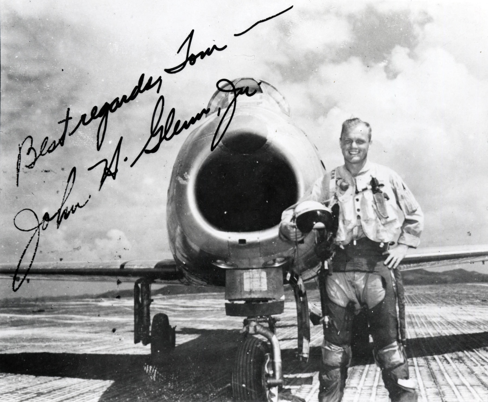 Wearing combat survival gear, John Glenn stands in front of his F-86F. The original photograph was autographed by Glenn to Tom Bartlett, an enlisted man in the 1st Marine Aircraft Wing who took the photo at K-3 airfield, Korea. (U.S. Air Force photo)