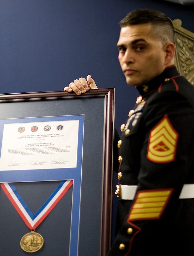 WASHINGTON - Retired Gunnery Sgt. Mario Monaco receives the Zachary and Elizabeth Fisher Distinguished Civilian Humanitarian Award for his work as chairman of the Lance Cpl. Chris Cosgrove III Marines Helping Marines program.  In addition to the certificate and medal, Monaco's name will be engraved on a trophy permanently on display at the Pentagon.  Monaco works with the Lance Cpl. Robert J. Slattery Detachment 206 at Picatinny Arsenal in Dover, NJ.