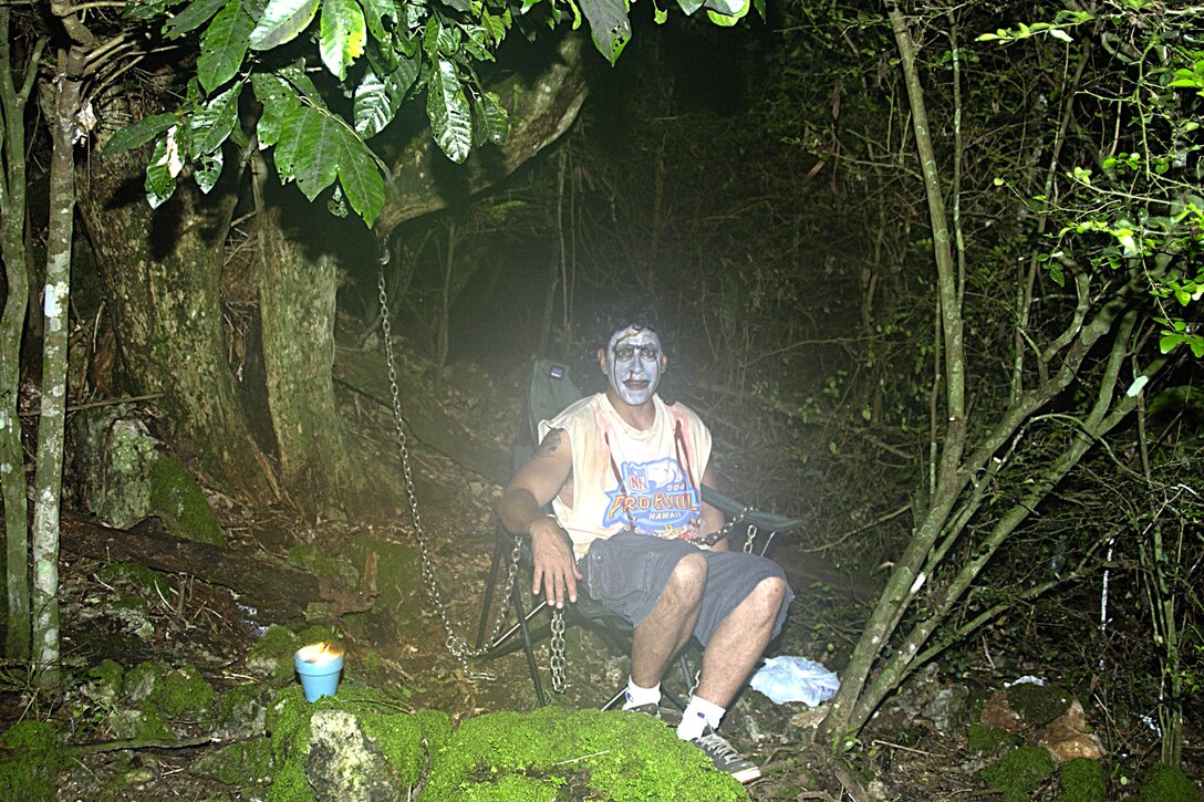 Pat Larson, 734th Air Mobility Squadron, scared people who were unaware of his presence as they walked by his alcove along the 734th AMS's Haunted Trail Oct. 27. (U.S Air Force photo/Airman 1st Class Carissa Morgan)