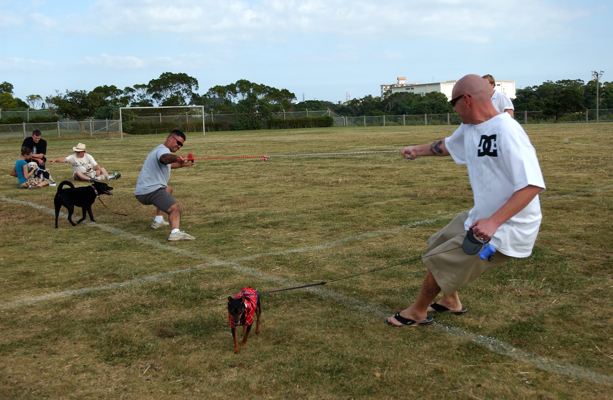 Gunnery Sgt. Albe Genao, 1st Marine Air Group, and Senior Airman Jason Krichten, 82nd Reconnaissance Squadron, compete for a dog prize through tug-of-war during Dogtoberfest near Chibana Golf Course, Okinawa, Japan, Oct. 28, 2007. Kadena Services held the event to get the military and local community involved by bringing out their pets and to socialize.
(U.S. Air Force photo/Tech. Sgt. Rey Ramon)
