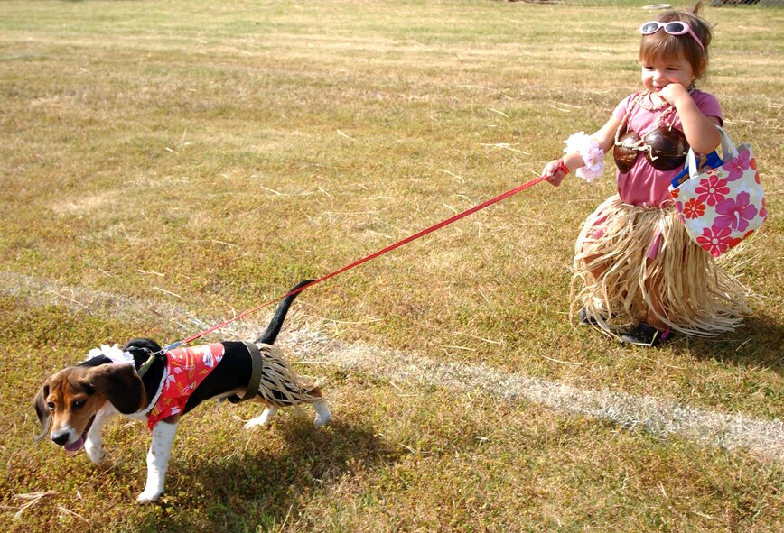 Gabriela Welsh, 2-year-old, walks the family dog, Sour Dough, around the soccer field during Dogtoberfest near Chibana Golf Course, Okinawa, Japan, Oct. 28, 2007. Kadena Services held the event to get the military and local community involved by bringing out their pets and to socialize.
(U.S. Air Force photo/Tech. Sgt. Rey Ramon)
