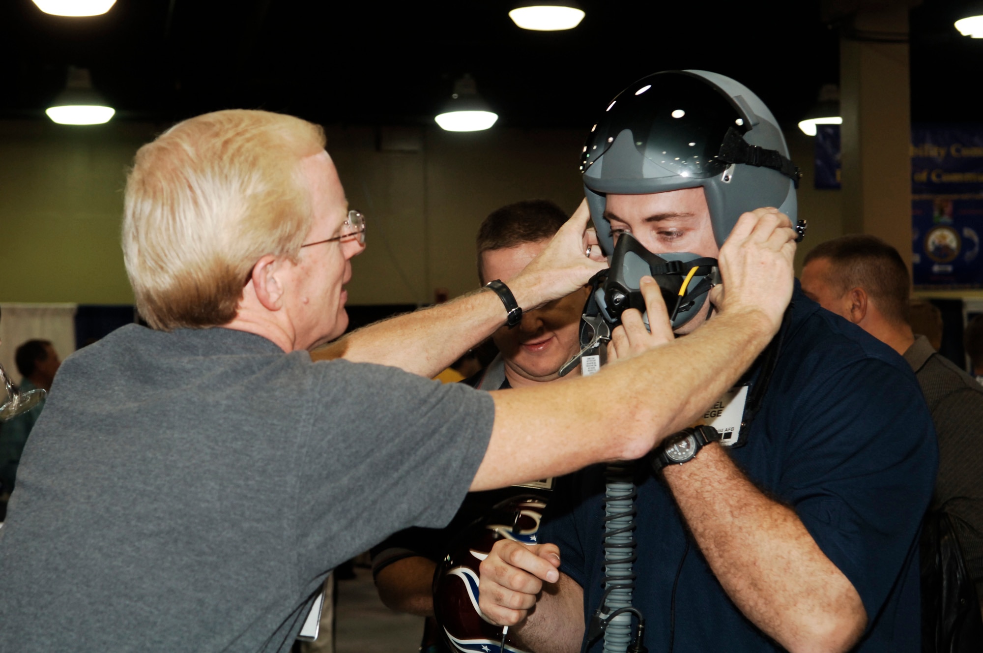 FAIRCHILD AIR FORCE BASE, Wash. -- 1st Lt. Michael Detiege, 92nd Communications Squadron base communications coordination center officer in charge, tries on a flight helmet during the Industry Aerospace Industry Show at the 39th annual Airlift Tanker Association convention and symposium. The industry show included products that ranged from new military clothing to aircraft engines. The flight helmet allows the pilot to continue to breathe normally in case of loss of cabin pressure or smoke in the cockpit. (U.S. Air Force photo/Senior Airman Chad Watkins)
