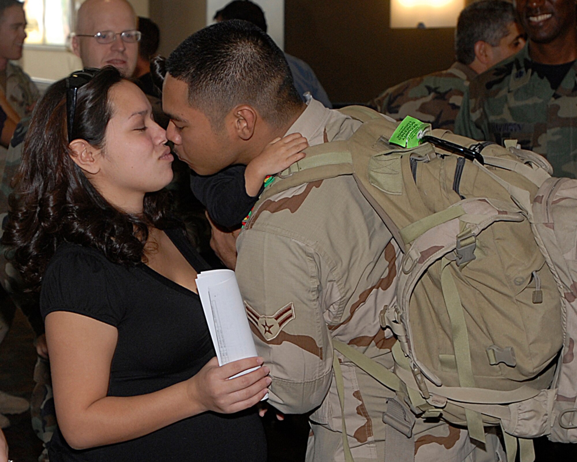 Airman 1st Class Solomon Quitugua, a patrolman with the 21st SFS, kisses his wife Mecaila at the Colorado Springs airport. Twenty-one Airmen from the 21st SFS returned from Afghanistan Oct. 29. (U.S. Air Force photo by Rob Lingley)