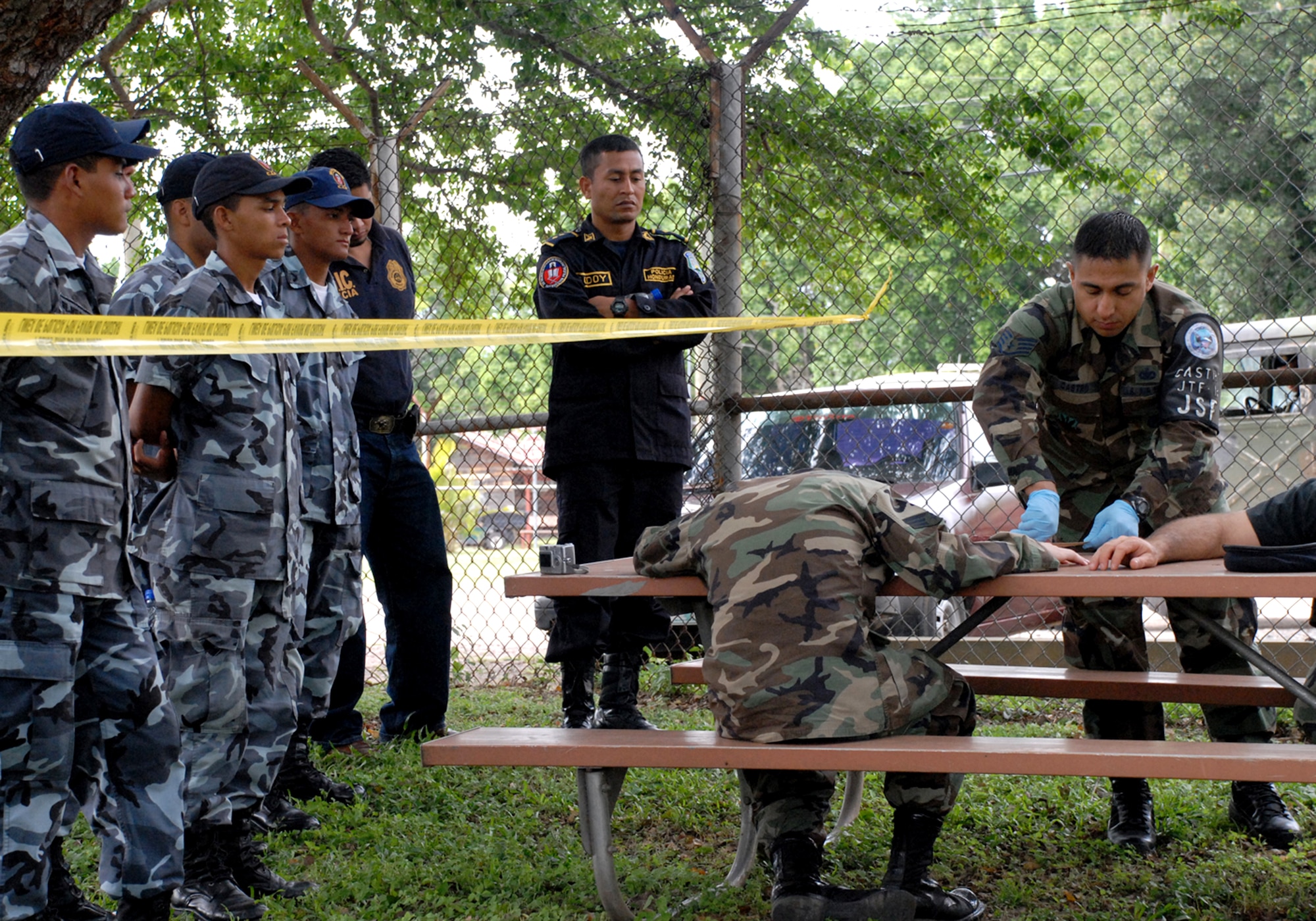 Staff Sgt. Edgar Castro, joint security forces, logs evidence from simulated victims during a training class with police from nearby Comayagua and La Paz police divisions, as well as cadets from the La Paz Police Academy. The crime scene processing course is one in a series of classes taught this year, with other lessons involving handcuff procedures, high-risk traffic stops and riot control. (U.S. Air Force photo/Tech. Sgt. Sonny Cohrs) 

