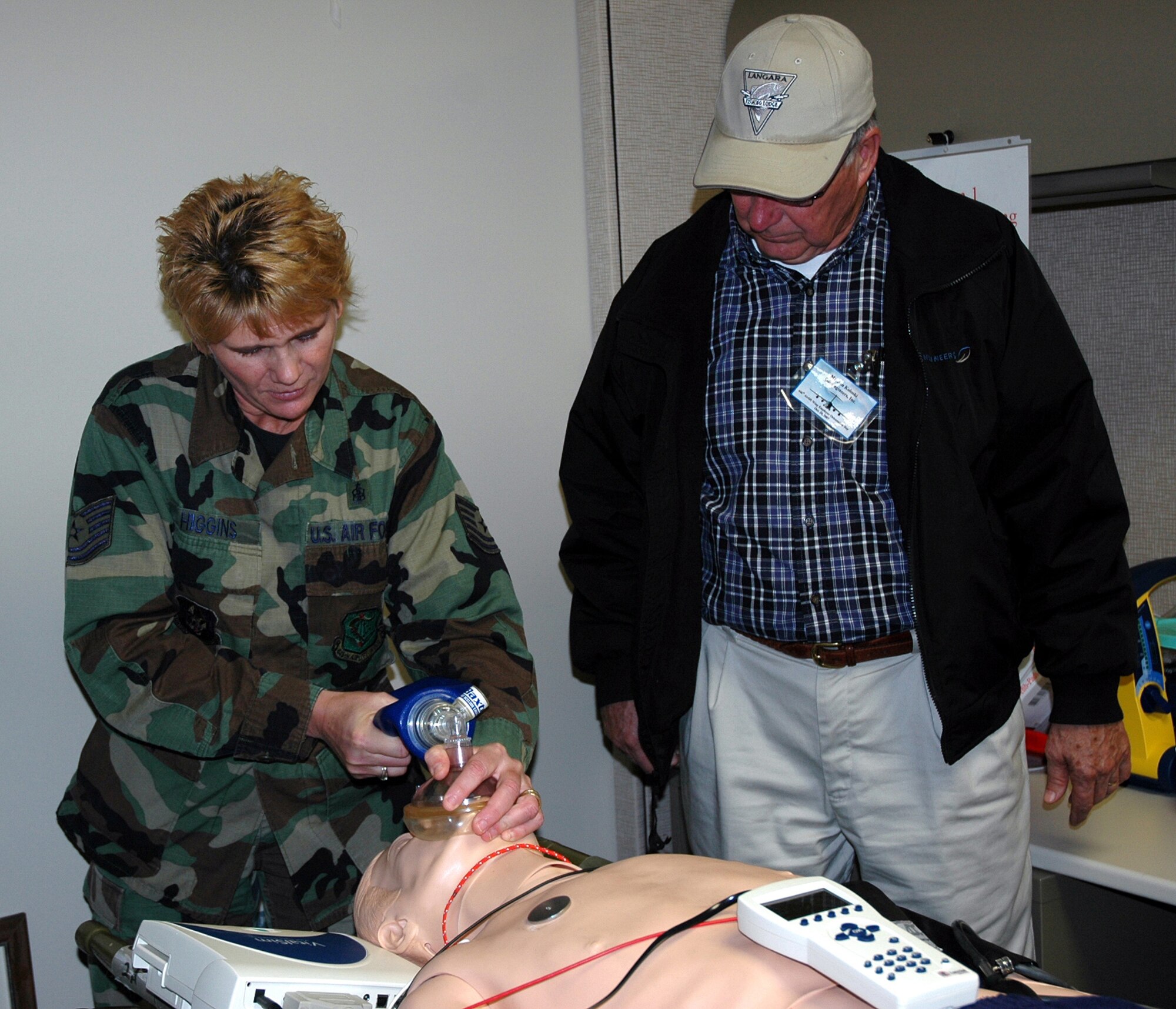 Tech. Sgt. Pam Higgins, 446th Aeromedical Staging Squadron, shows Jon Koloski how to give oxygen through a bag to a "patient," at the 446th ASTS Skills Lab.  Mr. Koloski, along with 36 other civilian employers of Air Force Reservists, spent Oct. 20 learning the jobs of their employees who also serve in the Air Force Reserve during the 446th Airlift Wing's Employer Orientation Day at McChord Air Force Base, Wash. (U.S. Air Force photo/Capt. Jennifer Gerhardt)  