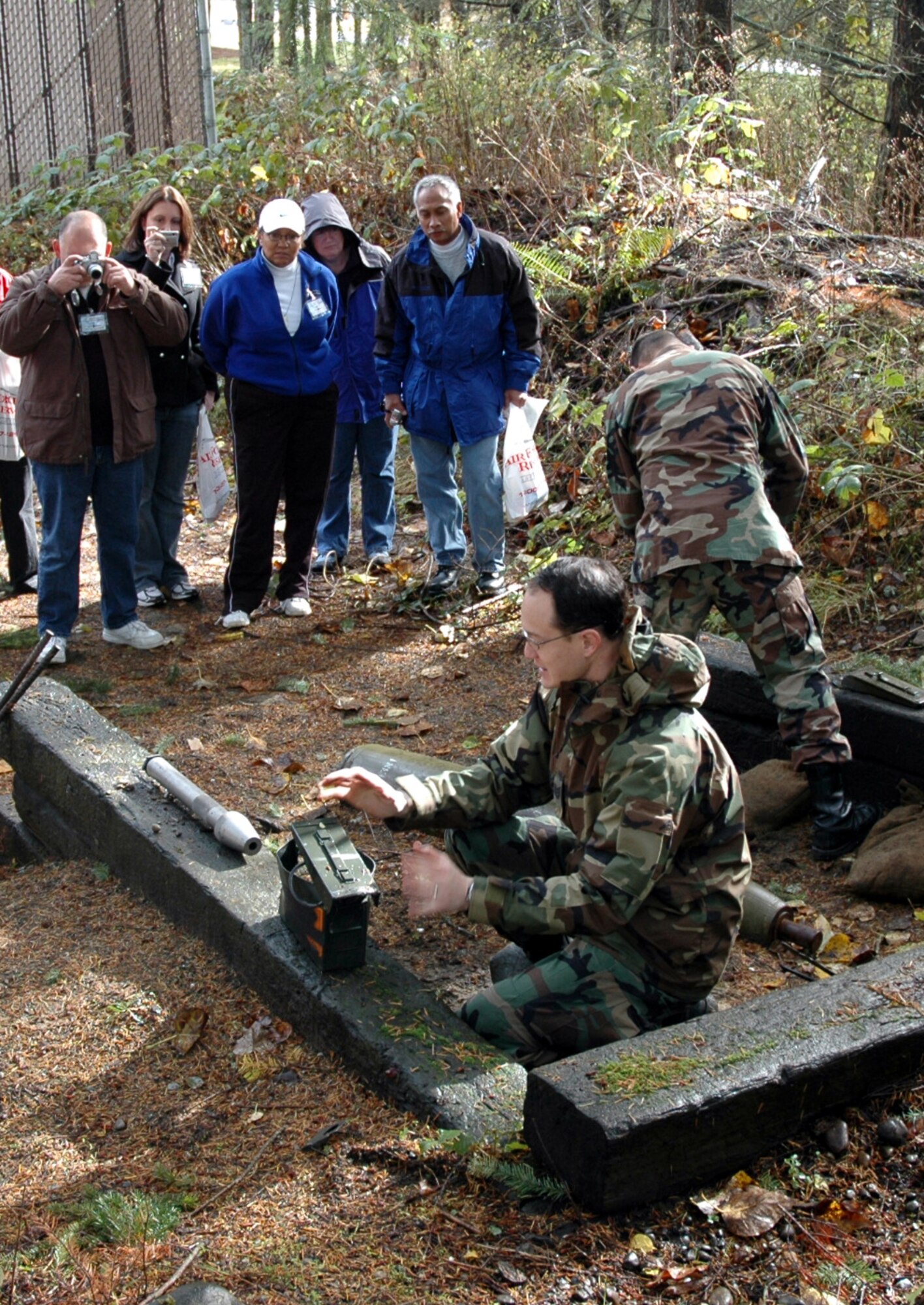 Staff Sgt. Keith Sekora, 446th Civil Engineer Squadron Explosive Ordnance Flight, shows and tells civilian employers how different bombs can be exploded and what the aftermath looks like.  The employers spent Oct. 20 learning about the jobs their employees do when they are serving in the Air Force Reserve with the 446th Airlift Wing. (U.S. Air Force photo/Senior Airman Grant Saylor)