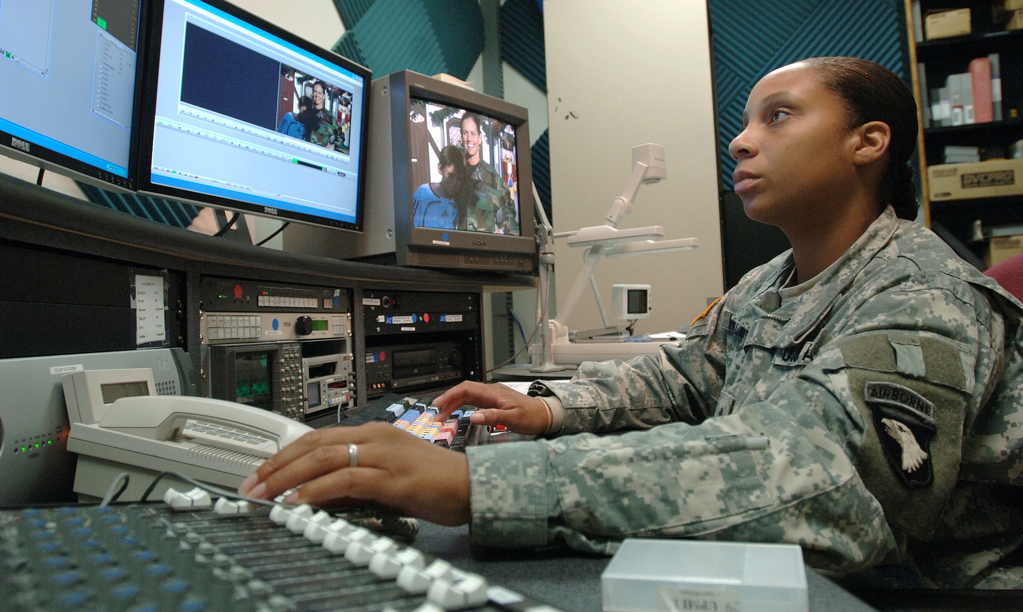 Army Sgt. Kimberly M. Williams edits a holiday greeting Oct. 30 at the Air Force News Agency in San Antonio.  Army and Air Force Hometown News "Greets" teams traveled to the Pacific, Europe and Southwest Asia videotaping military families sending holiday greetings to friends and family back in the U.S.  More than 7,000 greets have been collected so far this year, destined for commercial television stations across the Unites States.  (U.S. Air Force photo/Staff Sgt. Bennie J. Davis III)