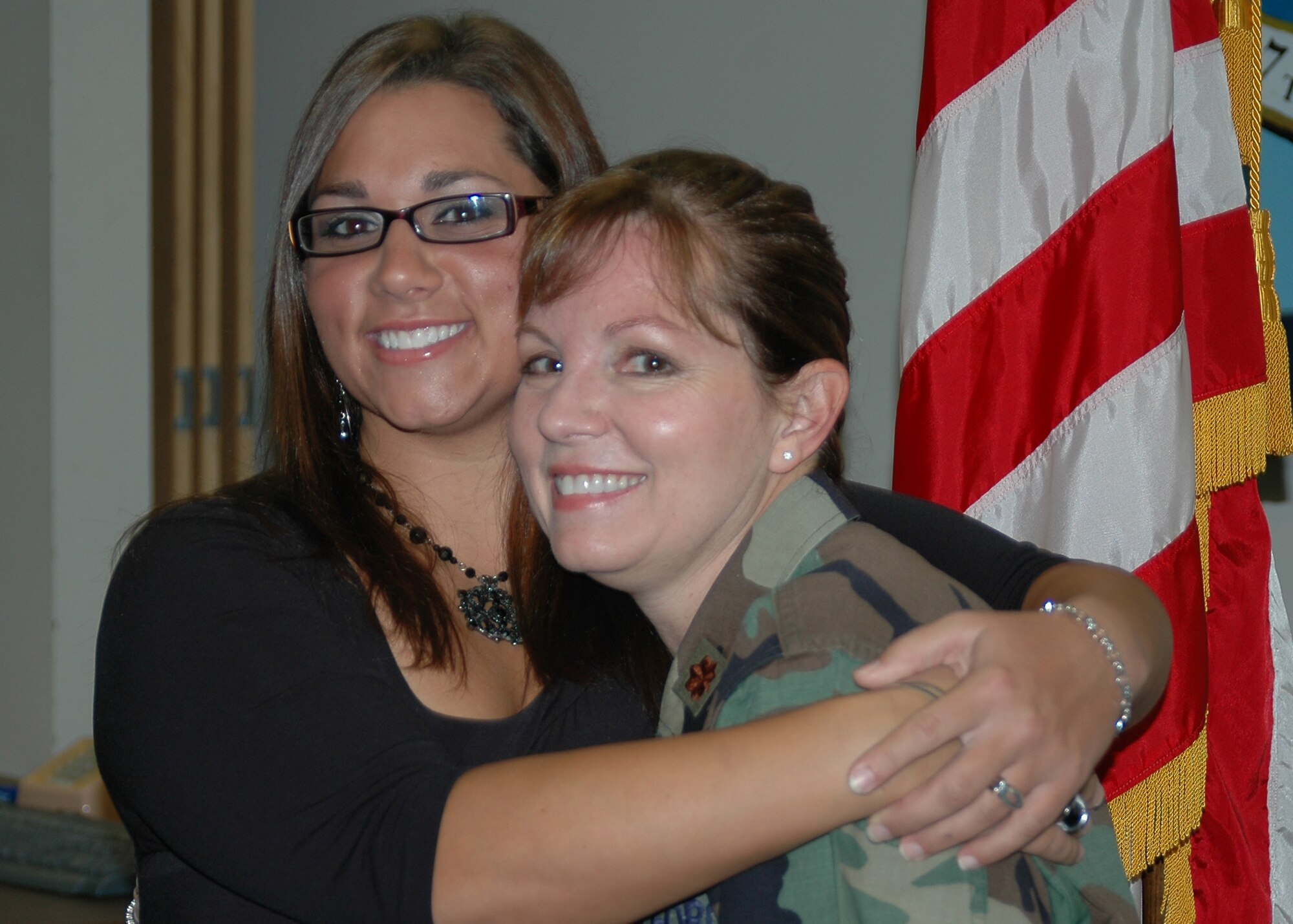 Amber Amburn gives her mom, Maj. Susan Geer, deputy commander of the 917th Medical Squadron, a big hug after taking the oath of enlistment Wednesday, Oct. 17. Andrea joins the 917th Wing to be a B-52 bomb navigator. (U.S. Air Force/Master Sgt. Sherri Bohannon)