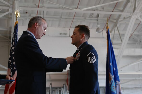 Col. Ed Walker, 917th Wing commander, pins the Bronze Star medal on Master Sgt. Kyle Waller, 917th Explosive Ordnance Disposal Flight technician Sunday, Oct. 14, at the quarterly Wing commander's call in the A-10 hangar, Barksdale AFB, La. (U.S. Air Force photo/Staff Sgt. Ebony Nichols)