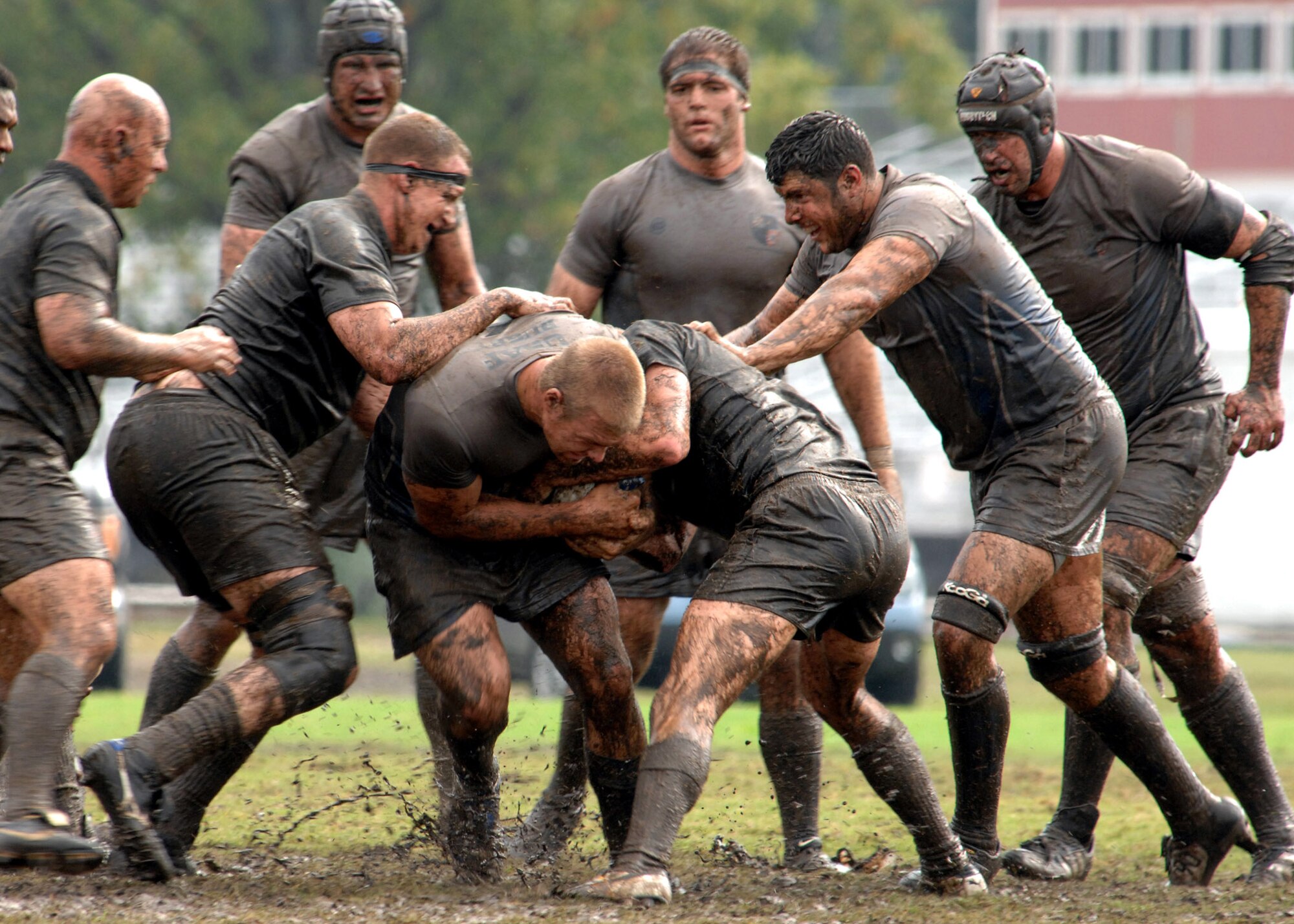Air Force rugby player Ryan Dombrock is tackled while his teammates prepare to ruck the defenders during the 2007 Armed Forces Rugby Tournament Oct. 27 at Marine Corps Base Camp Lejeune, N.C.  Air Force defeated the Army 22-5 for a fourth consecutive championship victory. (U.S. Air Force photo/Airman 1st Class Greg C. Biondo)