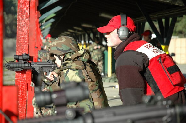 Firearms instructor Senior Airman Joshua Hartford, 446th Security Forces Squadron, McChord Air Force Base, Wash., watches an Air Force Reserve eam member prepare to fire the M4 during their annual firearms training Oct. 20 at Fort Lewis. (U.S. Air Force photo/Senior Airman Desiree Kiliz)