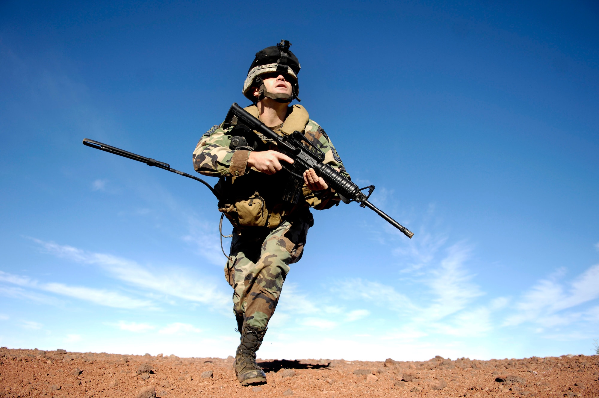 Tech. Sgt. Rick Setlock moves to another firing position during training Oct. 23 at the Pohakuloa Training Area on the big island of Hawaii. Sergeant Setlock is a tactical air control party member from the 25th Air Support Operations Squadron, Wheeler Army Airfield, Hawaii. The TACPs are training as part of the Koa Lighting exercise where bombers fly from Guam and practice their targeting. (U.S. Air Force photo/Tech. Sgt. Shane A. Cuomo)