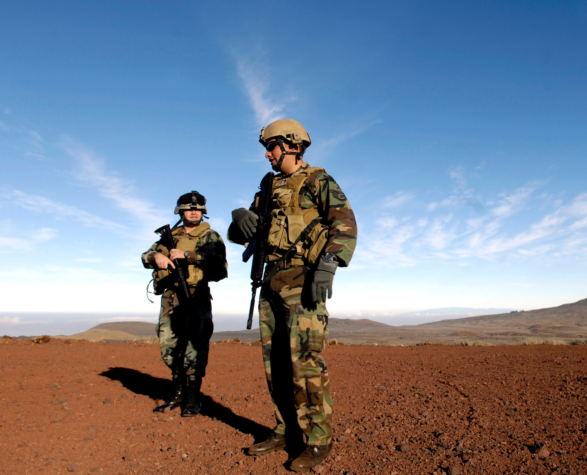 Tech. Sgt. Rick Setlock (left) and Staff Sgt. George Earhart wait to begin training Oct. 23 at the Pohakuloa Training Area on the big island of Hawaii. The Airmen are tactical air control party members from the 25th Air Support Operations Squadron, Wheeler Army Airfield, Hawaii. The TACPs are training as part of the Koa Lighting exercise where bombers fly from Guam and practice their targeting. (U.S. Air Force photo/Tech. Sgt. Shane A. Cuomo) 