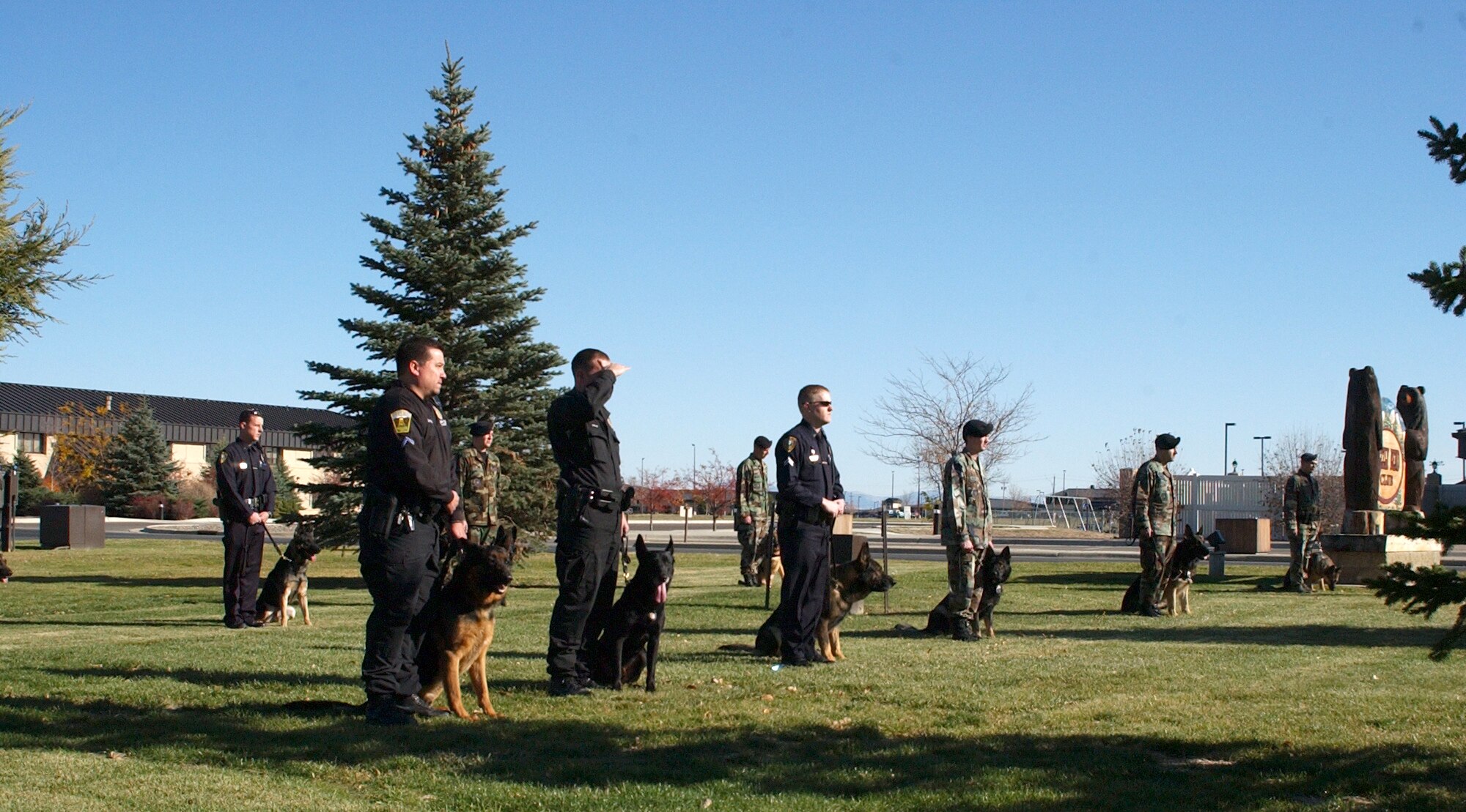 Members of the 341st Security Forces Squadron, Great Falls Police Department, Helena Police Department and a Pondera County police officer stand in observance as the Malmstrom Honor Guard honors the passing of 341st SFS military working dog, Brenda, who was euthanized Oct. 17 due to cancerous tumors in her respiratory system. (U.S. Air Force photo/Airman 1st Class Dillon White)
