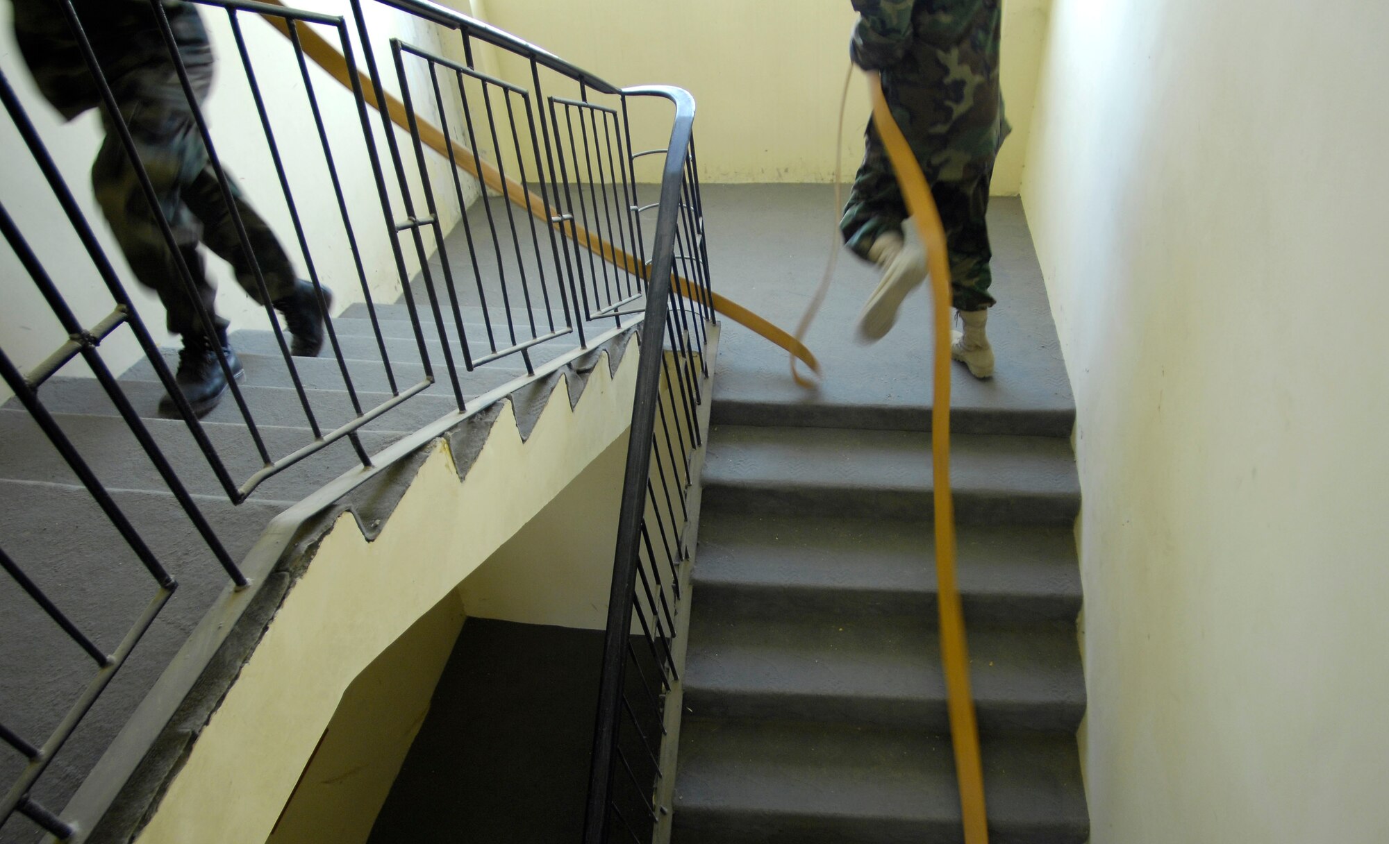 Afghan National Army Air Corps firefighters race up the stairs of a building at Kabul International Airport, Afghanistan, during a training exercise here.  The firefighters are training with Air Force mentors, to build their fire protection capability. (U.S. Air Force photo by Staff Sgt. Brian Ferguson)