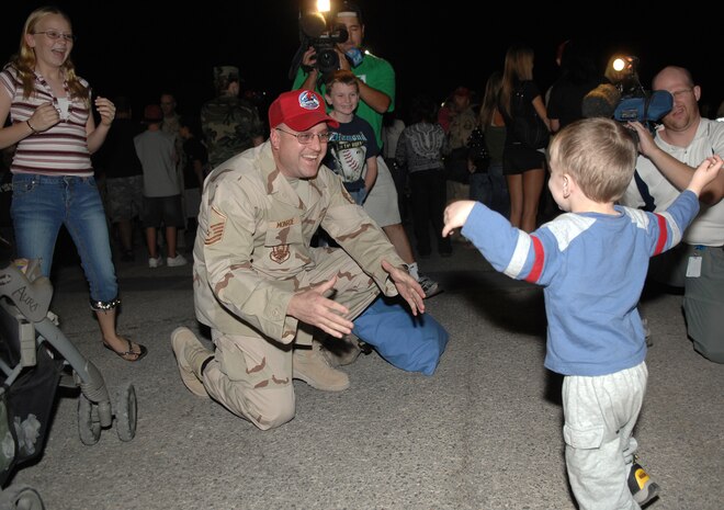 Oct. 28, Master Sgt. Roylyn Monroe, mechanical superintendant with the 820th RED HORSE Squadron who just returned from a deployment, greets his son after a seven-month-long separation. (Air Force photo by Airman 1st Class Brian Ybarbo)