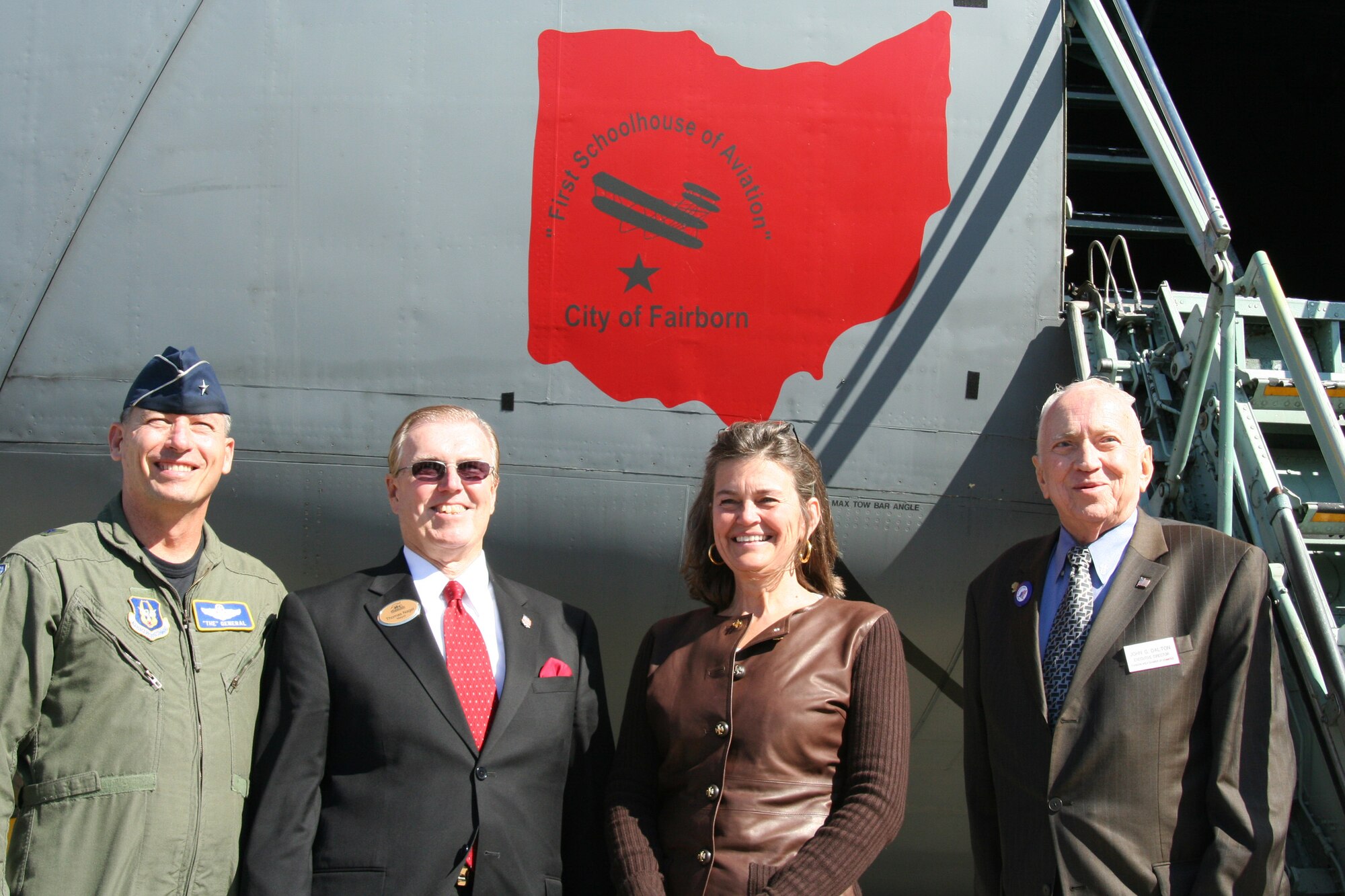 WRIGHT-PATTERSON AFB, Ohio - Brig. Gen. Bruce E. Davis, 445th Airlift Wing commander, Thomas H. Nagel, Mayor of the City of Fairborn, Amanda Wright-Lane, Great Grand Niece of the Wright Brothers, and John Dalton, Executive Director of the Fairborn Area Chamber of Commerce take a moment to pose with the nose art on the C-5 during a ceremony to dedicate the aircraft "City of Fairborn - First Schoolhouse of Aviation". (U.S. Air Force photo/Senior Airman Ken LaRock) 