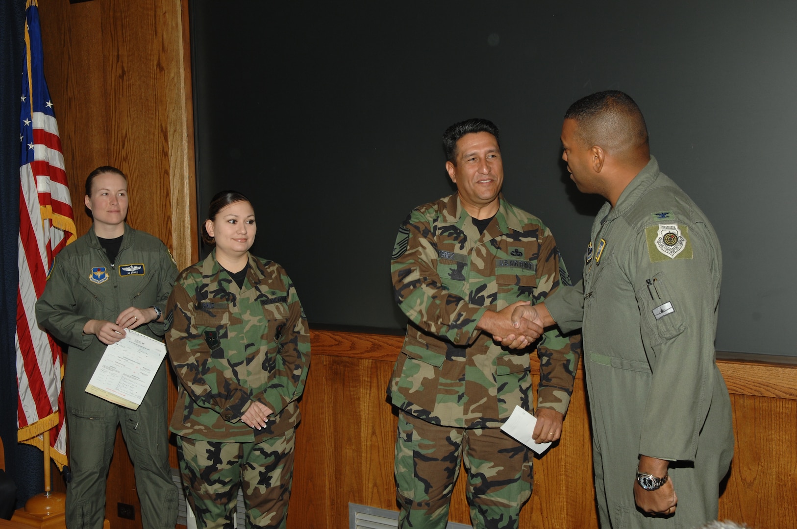 (Left Center) Senior Master Sgt. Ray Perez, Randolph Hispanic Council president, presents a $1,500 check to Col. Richard Clark, 12th Flying Training Wing commander, to be donated to the Boysville Childrens Home thorugh the Combined Federal Campaign on behalf of the wing and the Hispanic Council while (Far Left) Maj. Joey Dible, Randolph CFC project officer, and Staff Sgt. Miriam Saiz, Hispanic Council secretary, look on.    