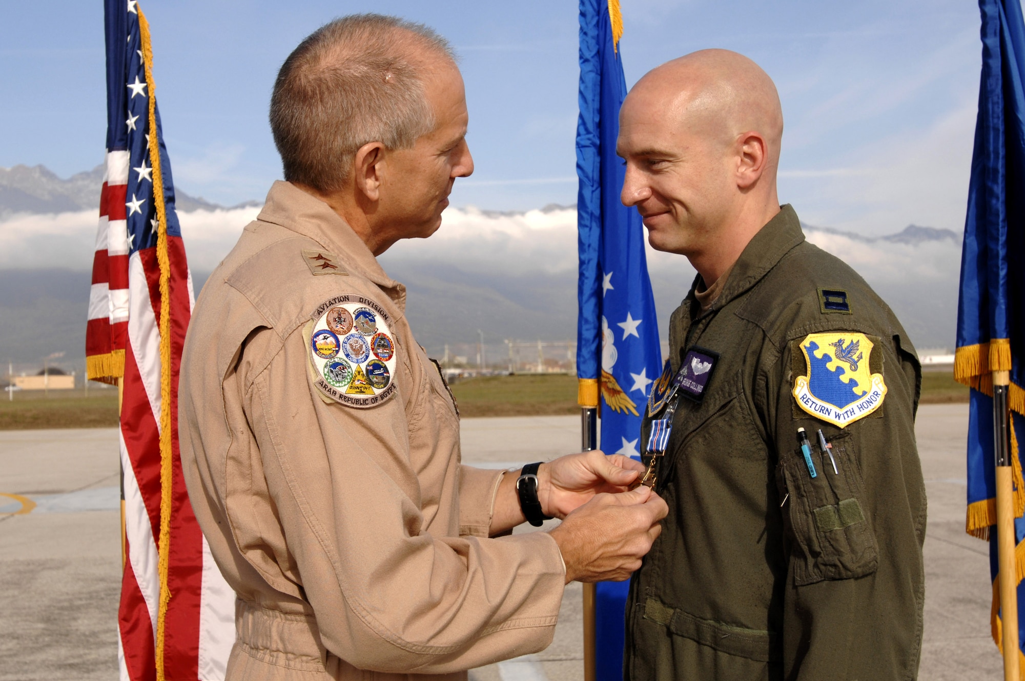 Maj. Gen. Michael Collings, the senior U.S. defense representative to Egypt, pins a Distinguished Flying Cross on Capt. George Collings Oct. 29 on the flightline here. General Collings flew into Aviano Air Base, Italy, to present Capt. Collings with the medal for distinguishing himself by extraordinary achievement while participating in aerial flight as an F-16 pilot with the 510th Expeditionary Fighter Squadron based out of Balad Air Base, Iraq. (U.S. Air Force photo/Senior Airman Patrick Dixon).
