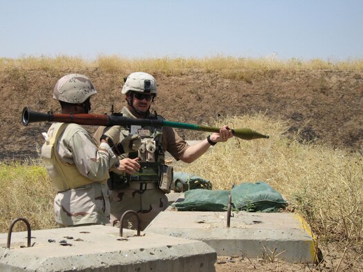 Master Sgt. Paul Tranetzke, 341st Missile Security Forces Squadron operations superintendent, teaches an Iraqi Forces interpreter how to properly load a rocket-propelled grenade during one-on-one training. Sergeant Tranetzke received the Bronze Star Oct. 25 for his efforts during Operation Iraqi Freedom April 2006 to 2007. (U.S. Air Force photo) 