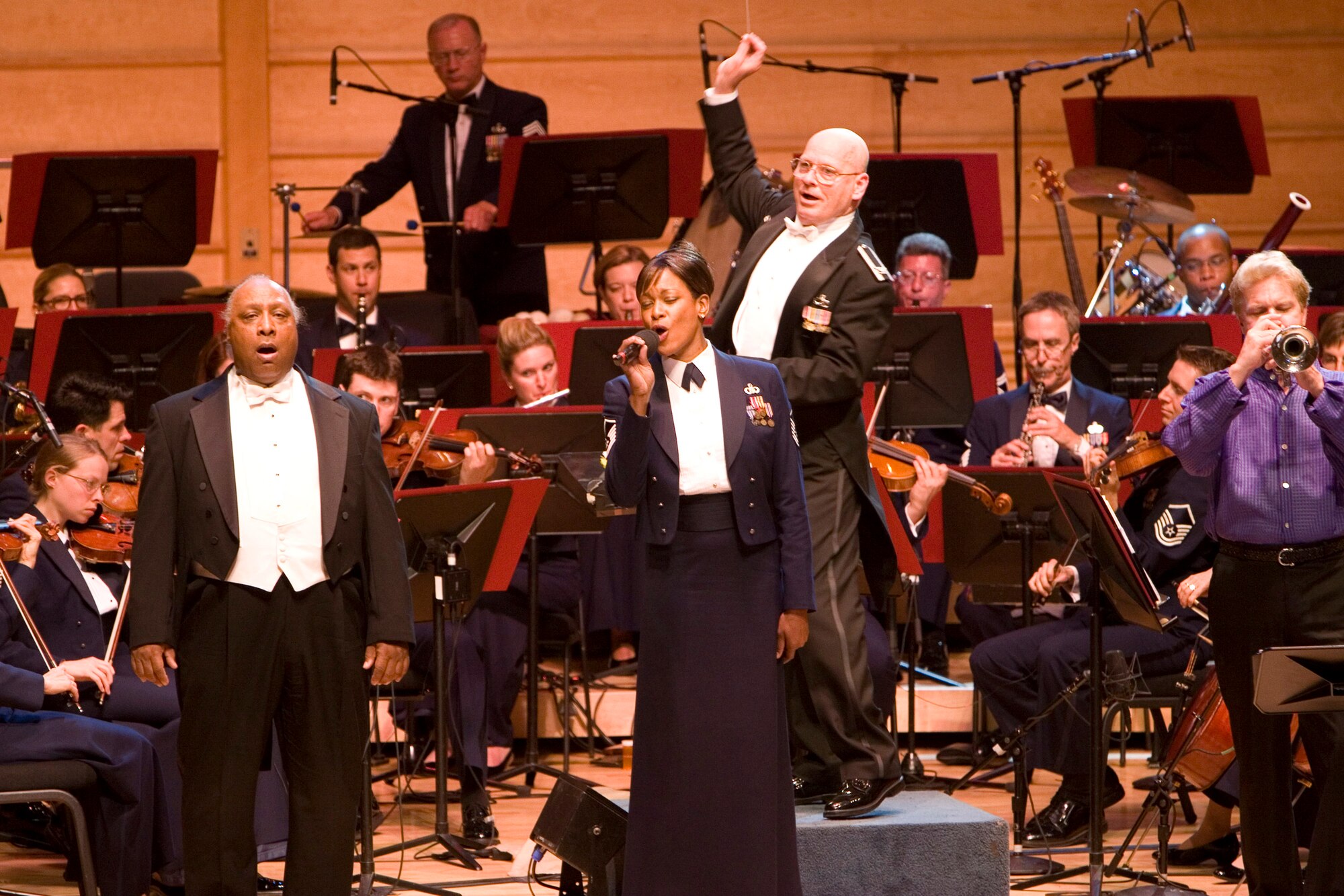 Thomas Young of The Tenors: Cook, Dixon and Young, Master Sgt. Shani Prewitt of the U.S. Air Force Band and Rolf Smedvig of Empire Brass perform in a concert celebrating the Air Force's 60th Anniversary. Conducted by Air Force Band commander and music director Col. Dennis Layendecker, the concert will be broadcast nationally on public television stations Veteran's Day 2007. (U.S. Air Force photo/Senior Master Sgt. Robert Mesite)