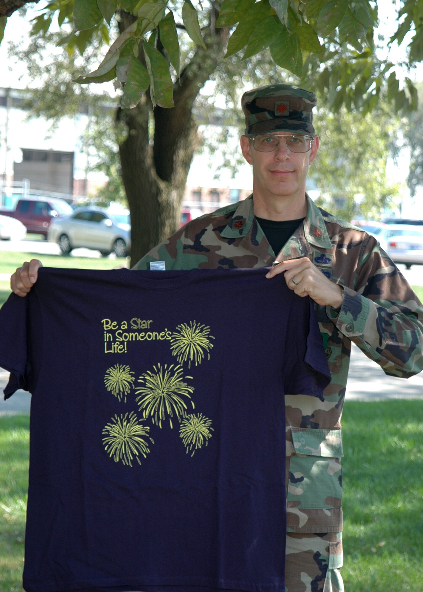 GRISSOM AIR RESERVE BASE, Ind. -- Maj. Shane D. Toomay, maintenance officer for the 434th Maintenance Group, holds up a t-shirt with this years theme for the Combined Federal Campaign. The CFC is the workplace fundraising campaign for Federal employees. For more infromation visit www.cfcindiana.org. (U.S. Air Force photo/ SrA Carl Berry)