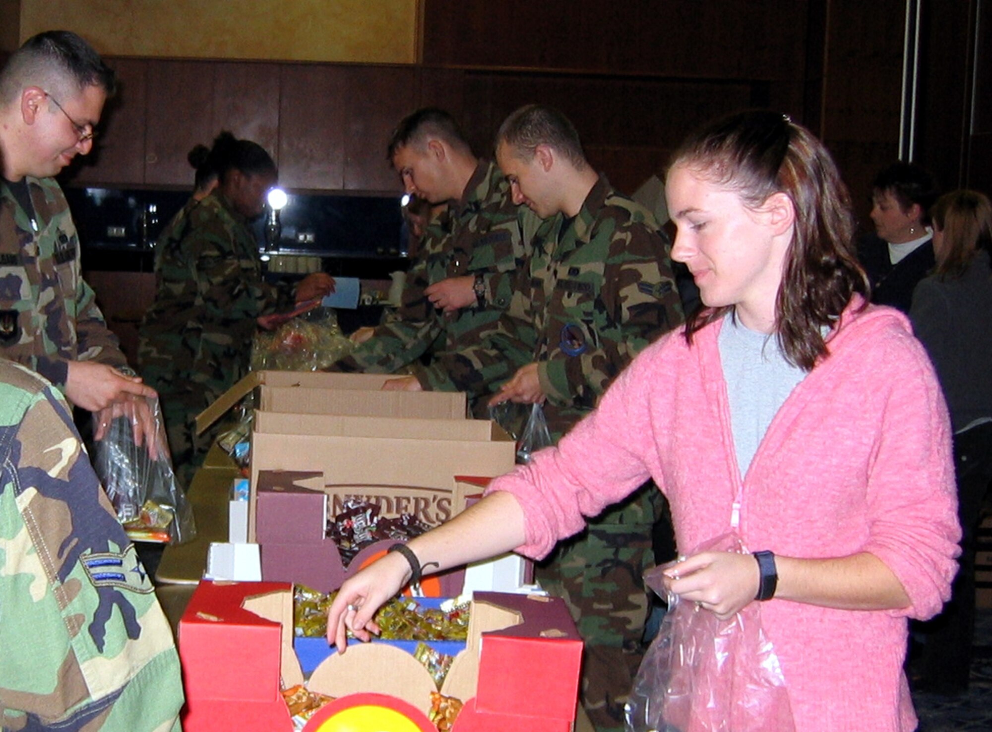 Sabers fill snack bags that will be distributed by members of Operation Open Arms to Airmen deploying from or through Spangdahlem Air Base in support of Operation Enduring Freedom or Operation Iraqi Freedom Oct. 24. (Courtesy photo) 