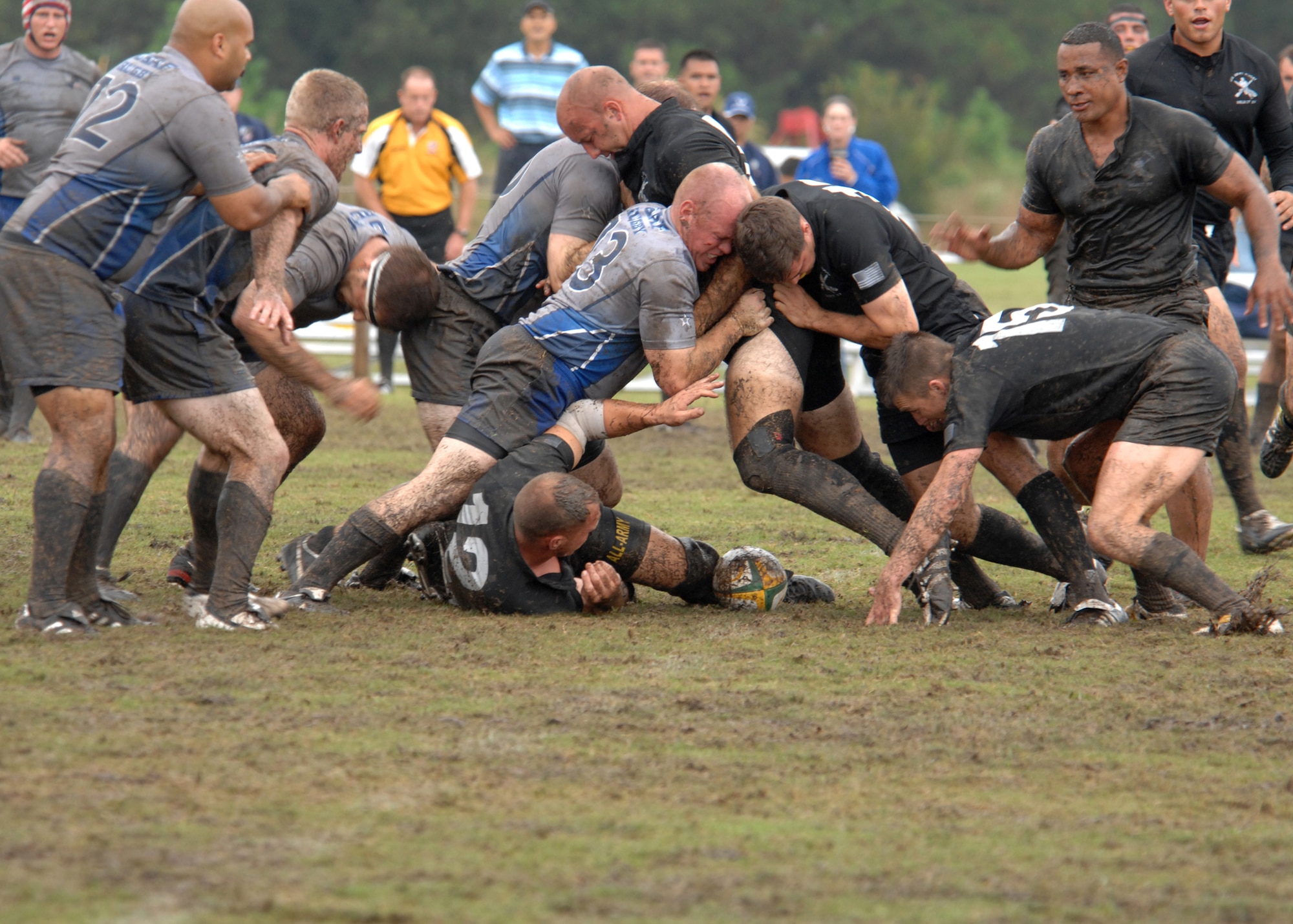 MARINE CORPS BASE CAMP LEJEUNE, N.C. - Two Army rugby players attempt to ruck Senior Airman James P. Hubby while attempting to retrieve the ball during the 2007 Armed Forces Rugby Tournament October 27. A ruck occurs when two players bind onto each other to attempt to push the opposition away from the ball. (U.S. Air Force photo by Airman 1st Class Greg C. Biondo)