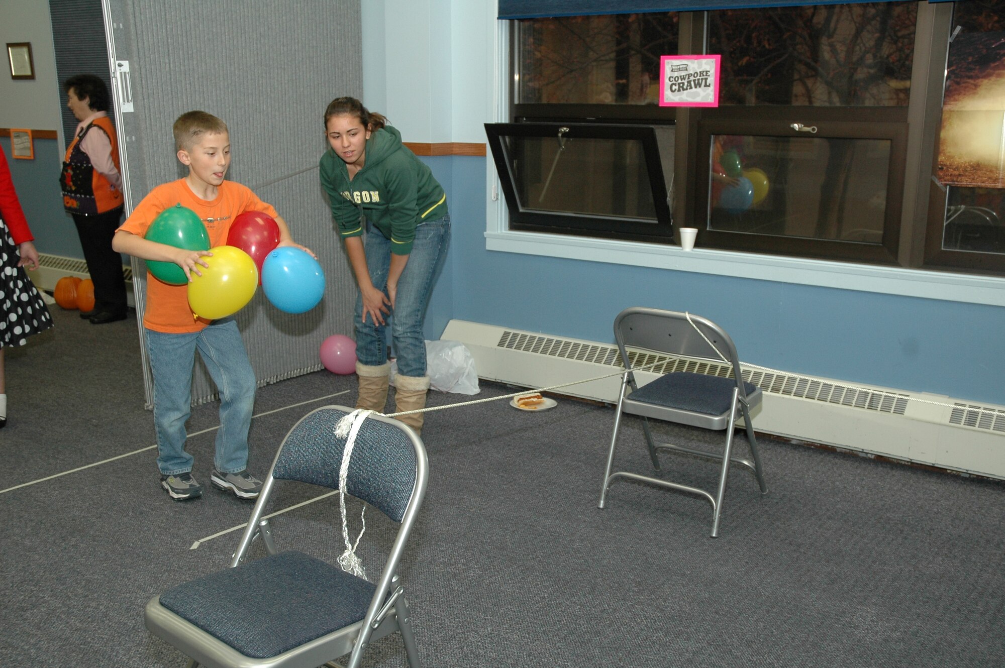 Little Warrior Gus, 10, takes on the Cowpoke Crawl at the chapel's Fall Harvest Festival as Darrian, 14, looks on. The festival was held Oct. 29 and was open to children of all ages. (U.S. Air Force photo/Airman 1st Class Emerald Ralston)