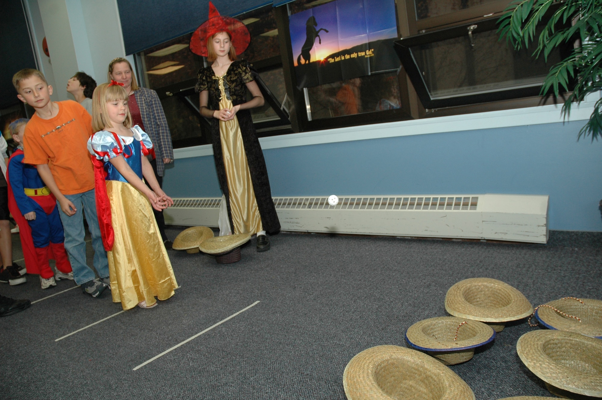 Little Warrior Audrey, 6, tosses a ball into cowboy hats at the chapel's Fall Harvest Festival Oct. 29. Games, crafts and prizes were available for the children to enjoy. (U.S. Air Force photo/Airman 1st Class Emerald Ralston)