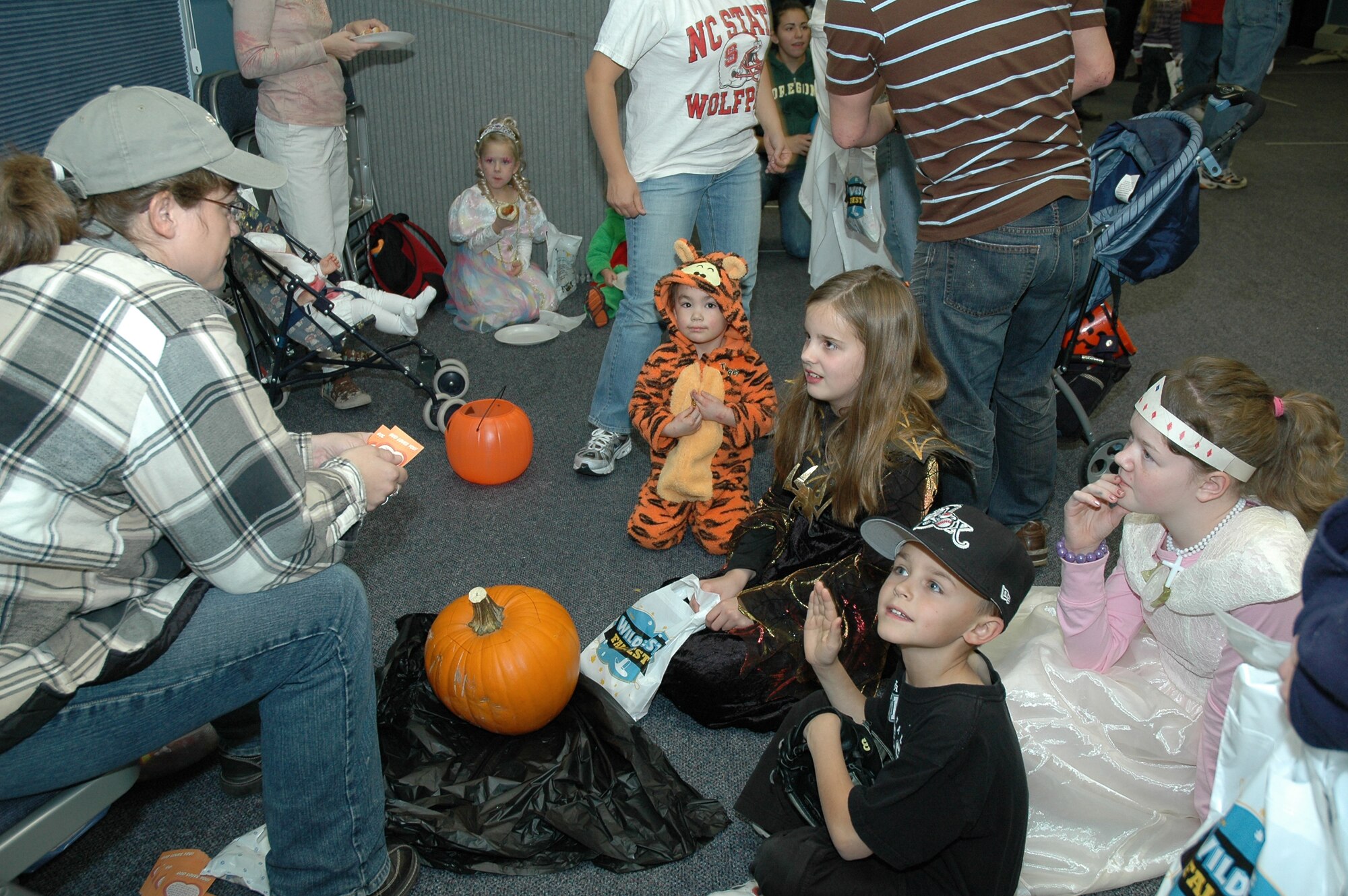Little Warriors gather around to hear stories at the chapel's Fall Harvest Festival Oct. 29. Games, crafts and food were available for the children to enjoy. (U.S. Air Force photo/Airman 1st Class Emerald Ralston)