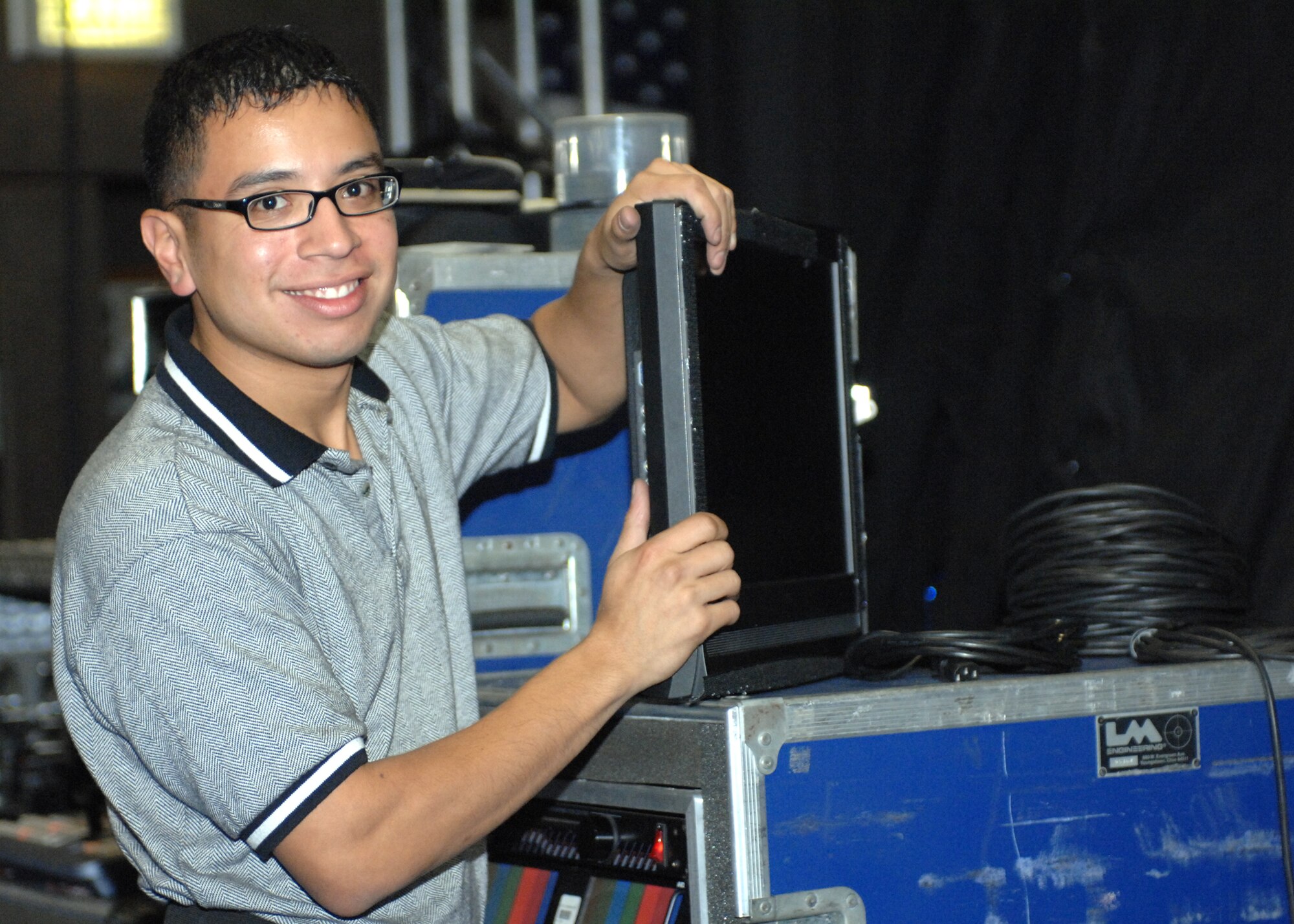 SPANGDAHLEM AIR BASE, Germany -- Senior Airman Jose Gutierrez, from the Air Force performance group Tops In Blue, prepares monitors to be set up on the stage at prior to the team’s performance at Skelton Memorial Fitness Center Oct. 29. (U.S. Air Force photo/Airman 1st Class Jenifer Calhoun) 