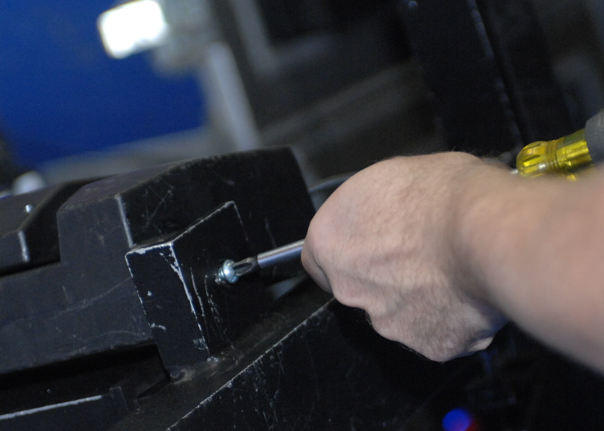 SPANGDAHLEM AIR BASE, Germany -- Senior Airman Rodney Mays, from the Air Force performance group Tops In Blue, puts together stage equipment prior to the teams performance at Skelton Memorial Fitness Center Oct. 29. (U.S. Air Force photo/Airman 1st Class Jenifer Calhoun)