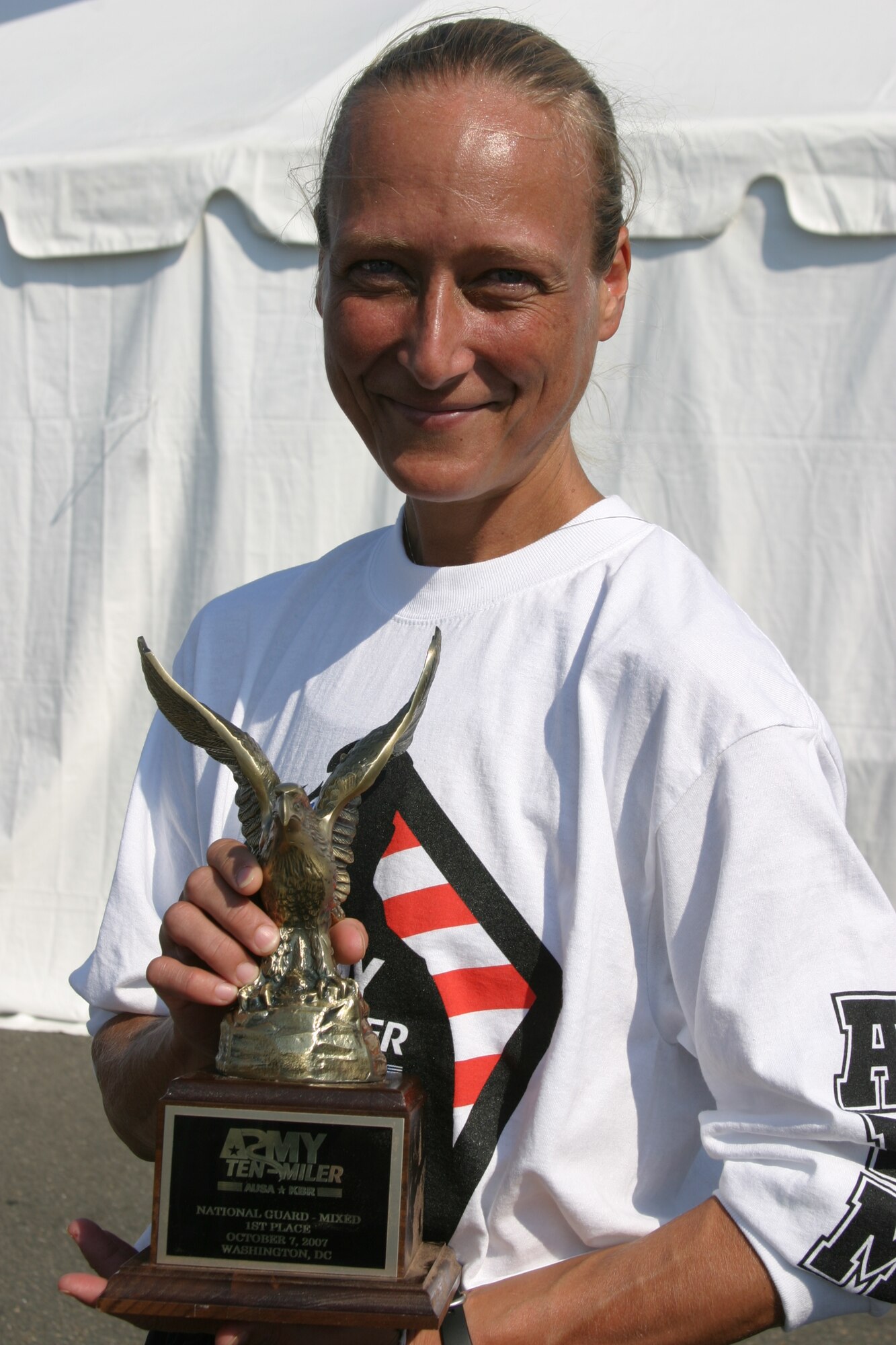 Army Staff Sgt. Michelle Elliott, of Knob Noster, displays the 1st place trophy her team won during the 23rd annual Army Ten-Miler in Washington, D.C. Oct. 7. (Photo printed with permission of Regina Turner)