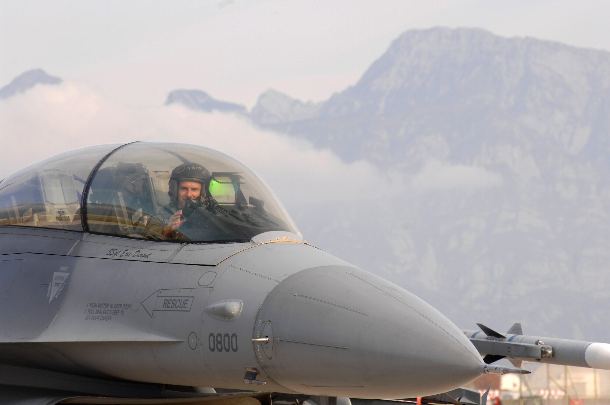 AVIANO AIR BASE, Italy--Capt. George Collings waves to his father, Major Gen. Michael Collings, the Senior U.S. Defense Representative to Egypt, as he taxis down the runway Oct. 29.  General Collings flew into Aviano Air Base to present Capt. Collings with the medal for distinguishing himself by extraordinary achievement while participating in aerial flight as an F-16CG pilot with the 510th Expeditionary Fighter Squadron based out of Balad Air Base, Iraq. (U.S. Air Force photo/Senior Airman Patrick Dixon) 
