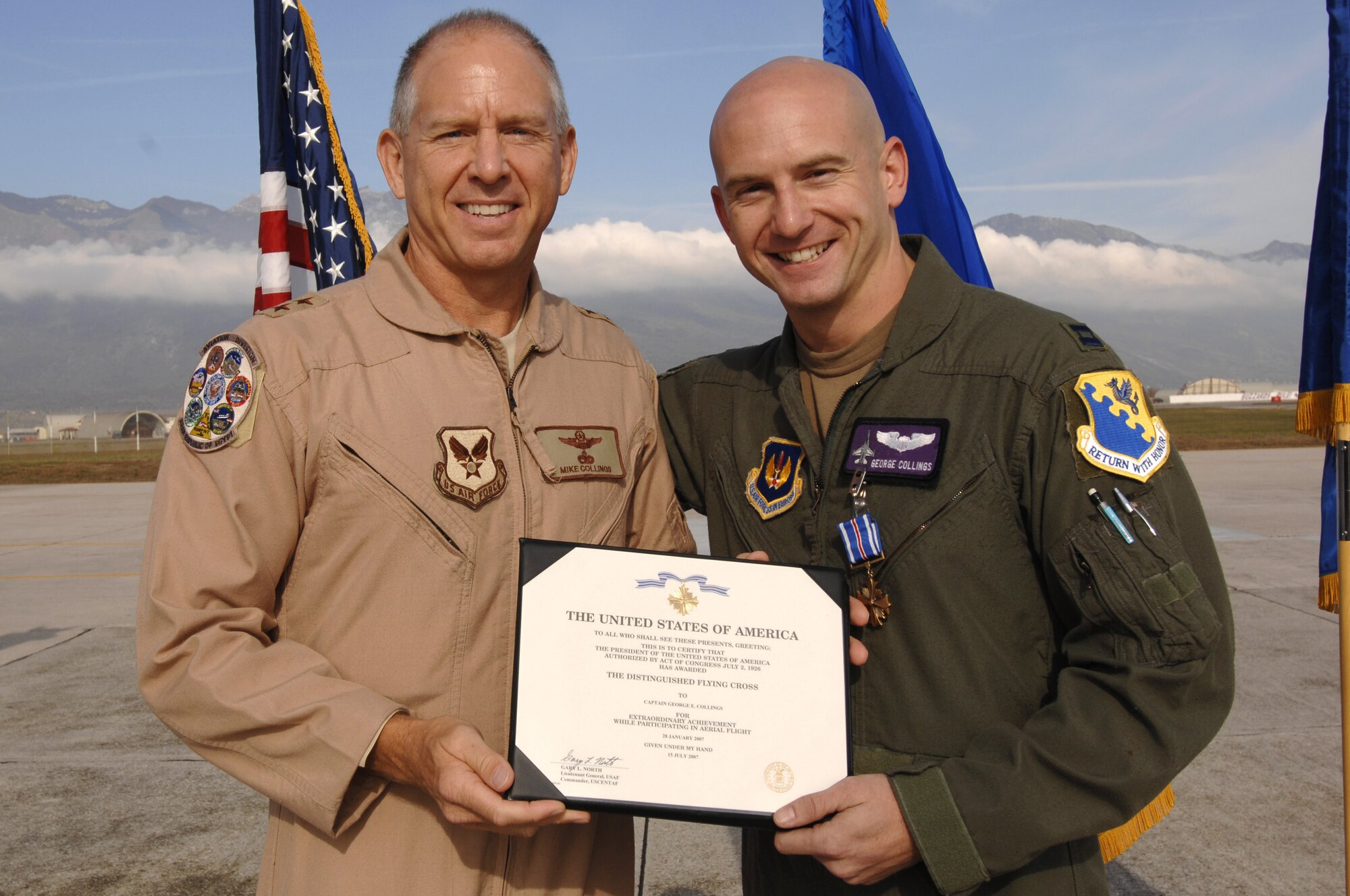 AVIANO AIR BASE, Italy--Capt. George Collings is presented the Distinguished Flying Cross on the flightline by his father and fellow F-16 pilot Major Gen. Michael Collings, the Senior U.S. Defense Representative to Egypt. General Collings flew into Aviano Air Base to present Capt. Collings with the medal for distinguishing himself by extraordinary achievement while participating in aerial flight as an F-16CG pilot with the 510th Expeditionary Fighter Squadron based out of Balad Air Base, Iraq. (U.S. Air Force photo/Senior Airman Patrick Dixon) 