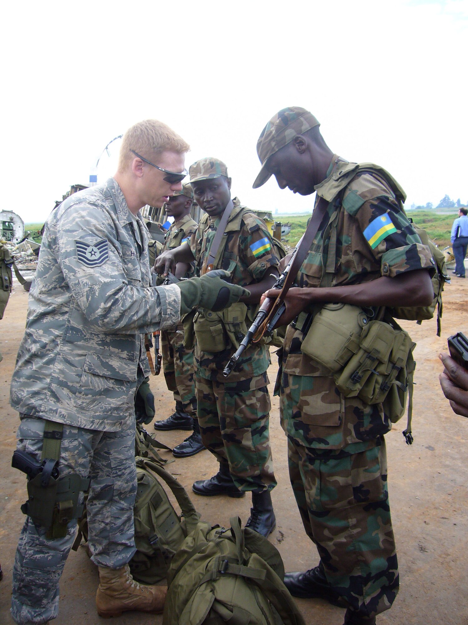 Tech. Sgt. Nate Hogan, 786th Air Expeditionary Squadron Security Forces, conducts a weapons check before boarding Rwandan Soldiers onto a C-17 en route to the Darfur region of Sudan Oct. 24 at Kigali International Airport in Kigali, Rwanda .  

