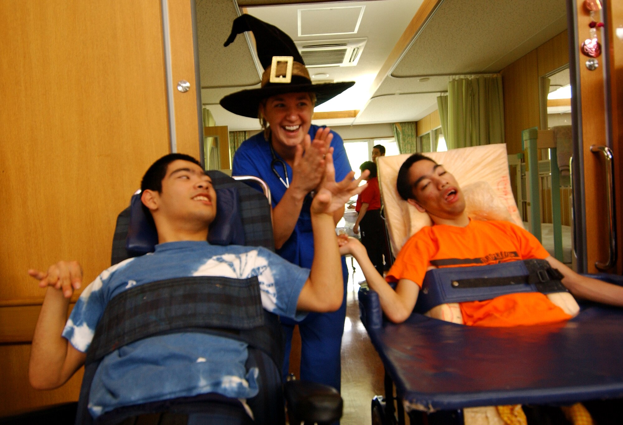 Airman First Class Sarah Holley, 353rd Maintenance Squadron, cheers the disabled children along during a musical chair skit at the Okinawa Children Development Center in Okinawa, Japan, Oct. 27, 2007.
(U.S. Air Force photo/Tech. Sgt. Rey Ramon)
