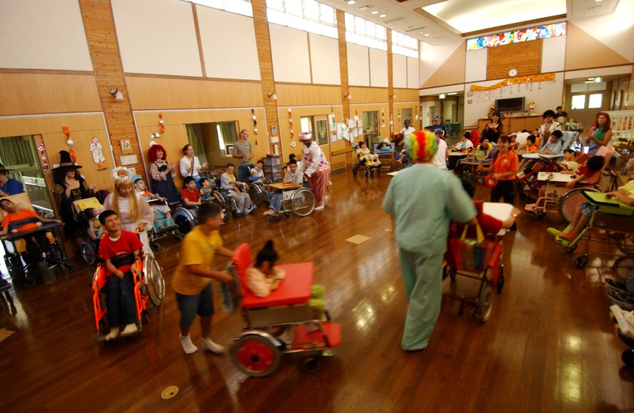 Airmen and family members of Kadena participate in a musical chair skit with physically disabled children from the Okinawa Children Development Center in Okinawa, Japan, Oct. 27, 2007.
(U.S. Air Force photo/Tech. Sgt. Rey Ramon)
