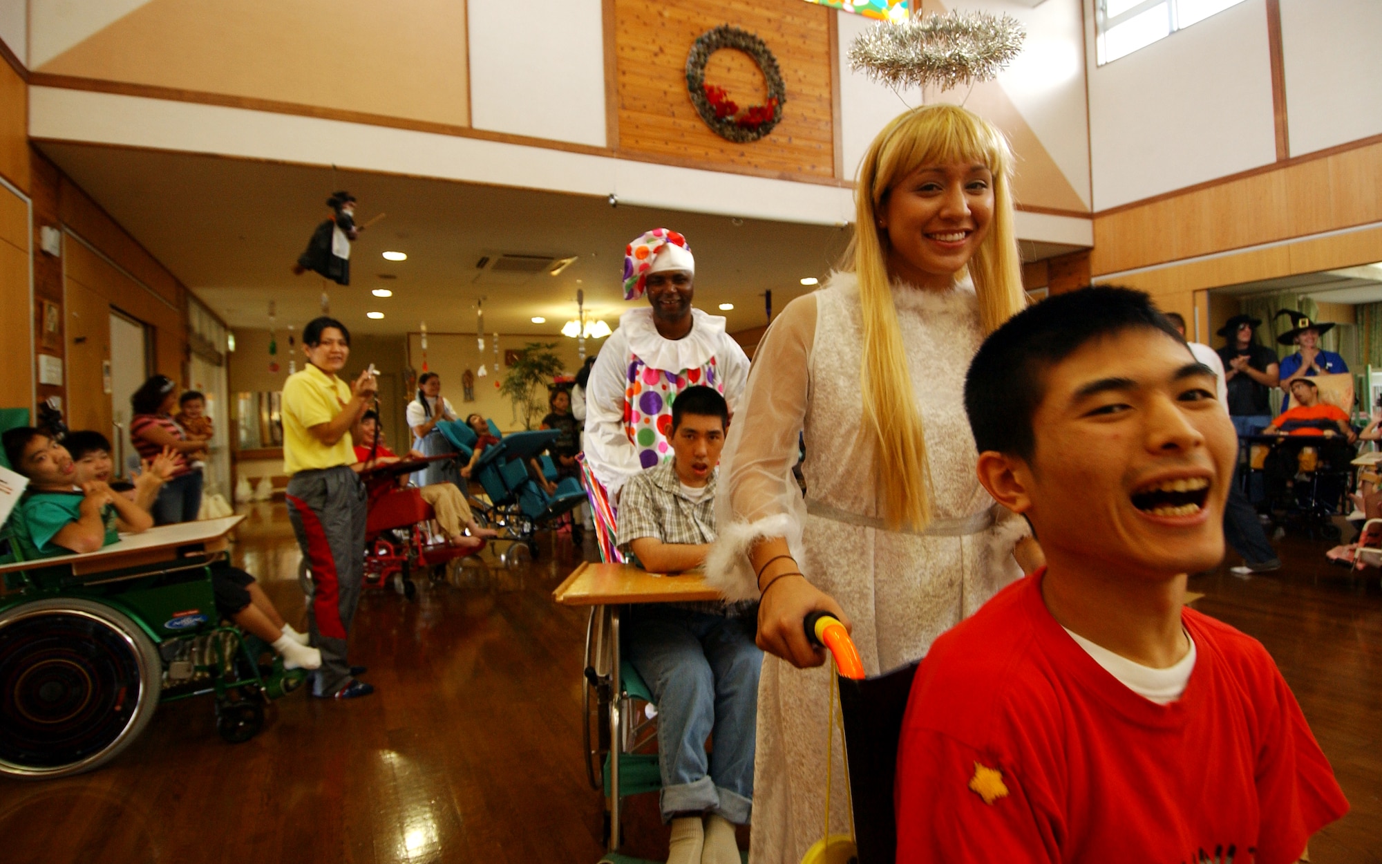 Staff Sgt. Julie Anzo, 17th Special Operations Squadron, and Master Sgt. Marvin Parker, 31st and 33rd Rescue Squadron first sergeant, participate in a musical chair skit with physically disabled children from the Okinawa Children Development Center in Okinawa, Japan, Oct. 27, 2007.
(U.S. Air Force photo/Tech. Sgt. Rey Ramon)

