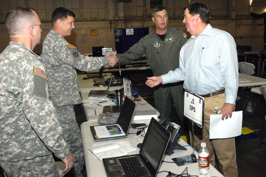 Maj. Gen. Robert Duignan, commander, 4th Air Force, right back, and Congressman Ken Calvert, California’s 44th District representative, right front, thank members of the Army North command for establishing an operational command post at March Air Reserve Base to provide command and control for all Department of Defense forces who arrived in the area to combat the Southern California wildfires.  (U. S. Air Force photo by Senior Airman Daniel St. Pierre)
