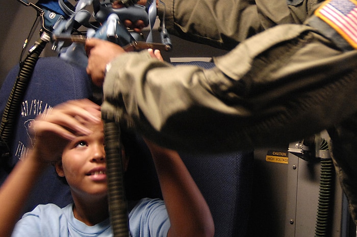 A boy with the Combined Federal Campaign's Shadow Program tries on a mask while on a C-17 during a visit to the base Oct. 26.  The CFC Shadow Program is an event sponsored by the Air Force Combined Federal Campaign. More than 60 boys and girls from the Charleston area came to the base to learn about the Air Force.  (U.S. Air Force photo/Staff Sgt. Richard Rose)