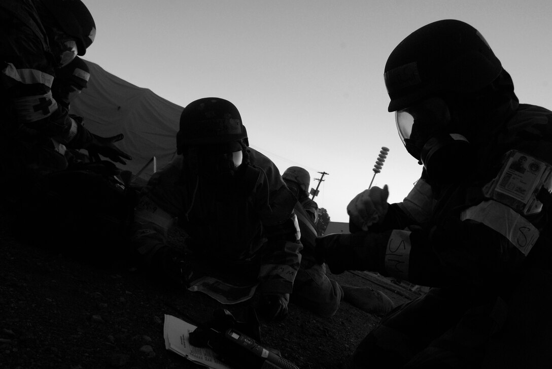 LANGLEY AIR FORCE BASE, Va. -- Members of the 1st Medical Group don their chemical gear in a simulated bunker during the Phase II exercise Oct. 31.  The Phase II exercise trains Airmen to deal with various war time contingencies in a simulated environment.  (U.S. Air Force photo/Senior Airman Christopher L. Ingersoll)