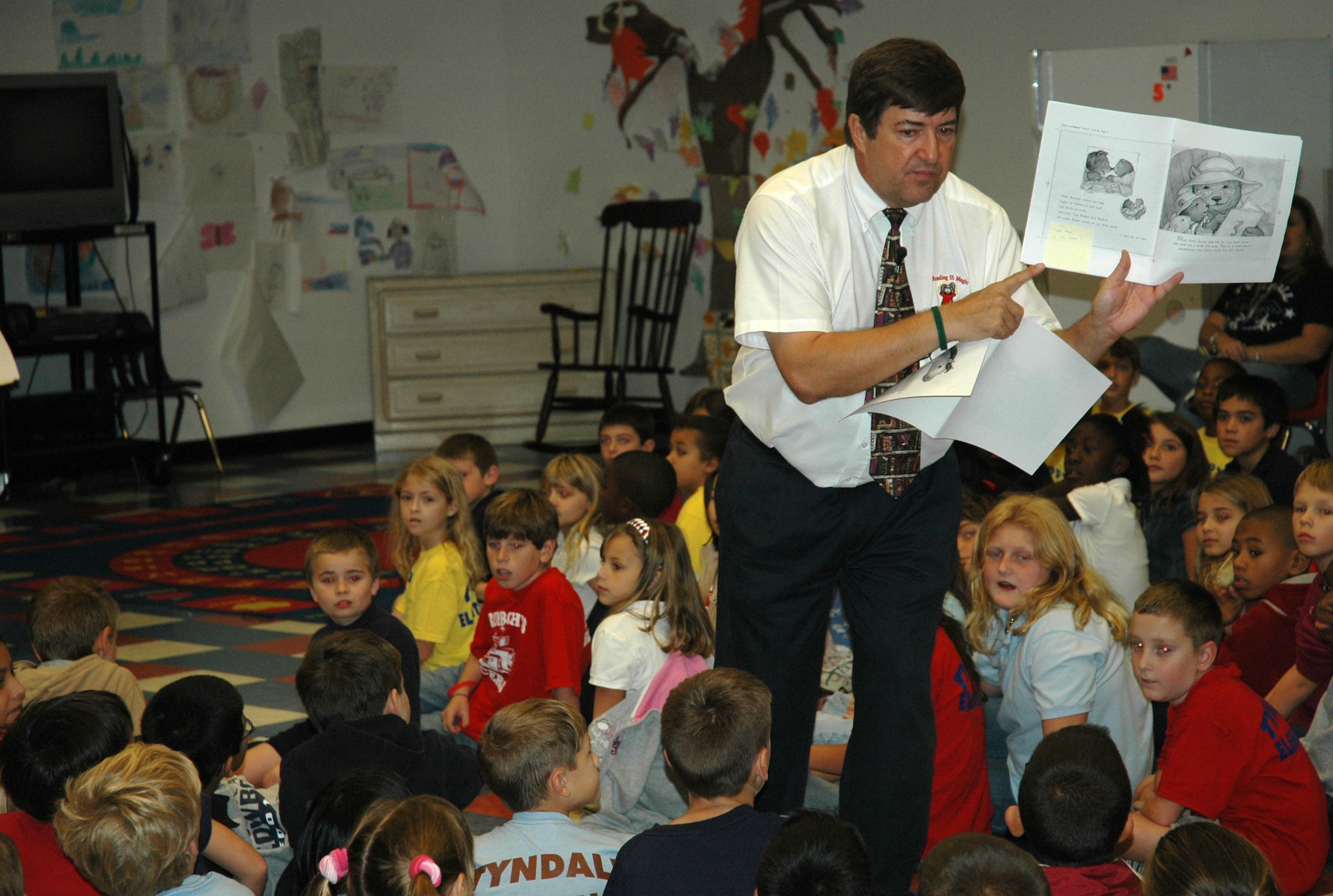 Childrens Author Michael Shoulders, reads one of his nine books to children during a presentation at Tyndall Air Force Base Elementary School here Oct. 26.  Mr. Shoulders read to all of the children at the school between Oct. 25 and 26 as part of a nation-wide tour.  (U.S. Air Force photo by Staff Sgt. Timothy R. Capling)