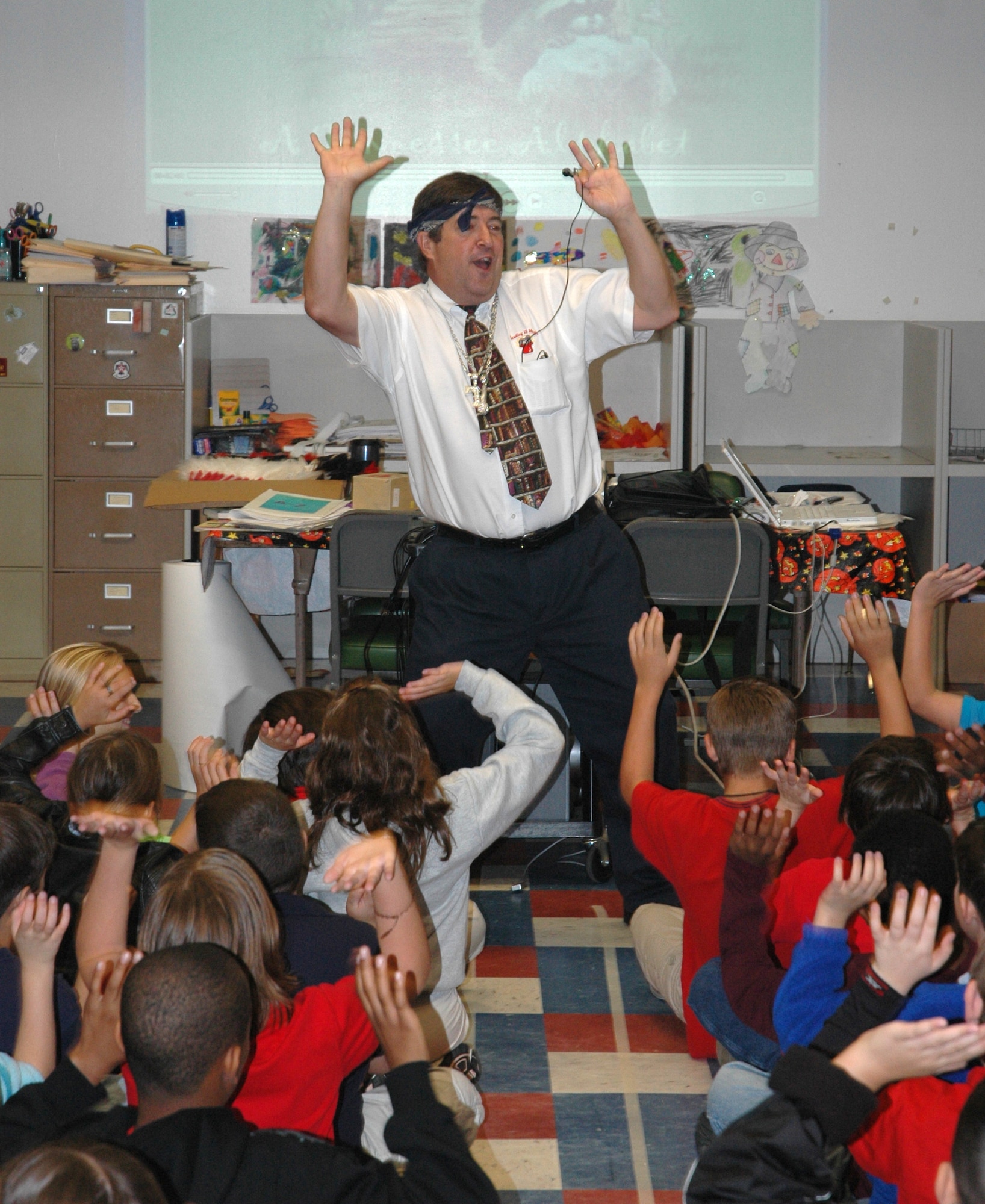 Author Michael Shoulders demonstrates to children at Tyndall Air Force Base Elementary School the process of writing using his rap song.  Shoulders is scheduled to tour other Bay County, Fla. schools thorough out November.  (U.S. Air Force photo/Staff Sgt. Timothy R. Capling)