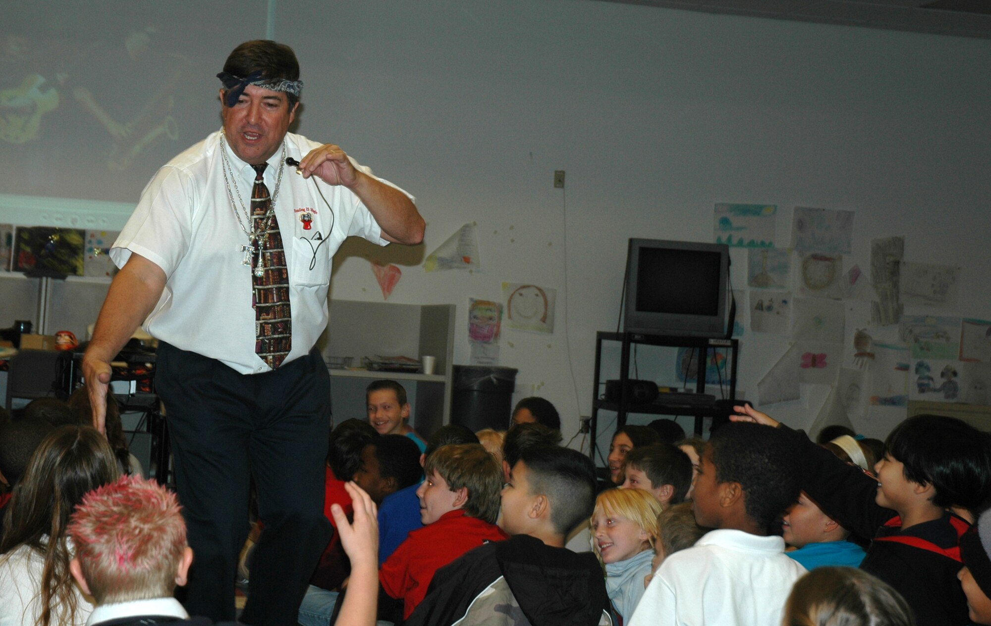 Author Michael Shoulders, gives a student a high-five during his presentation to Tyndall Air Force Base Elementary School here Oct. 26.  Mr. Shoulders is a retired teacher and administrator from Clarksville, Tenn.  (U.S. Air Force photo/Staff Sgt. Timothy R. Capling)