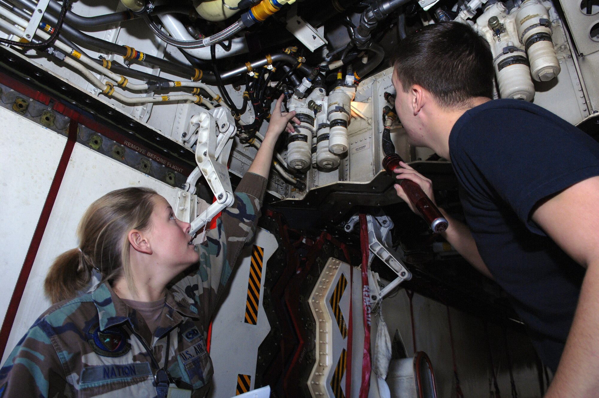 WHITEMAN AIR FORCE BASE, Mo. – Airmen 1st Class Lacey Nations and Jamie Forkner from the 509th Aircraft Maintenance Squadron, perform an hourly post inspection on the Spirit of Pennsylvania. (U.S. Air Force photo/Airman 1st Class Stephen Linch)