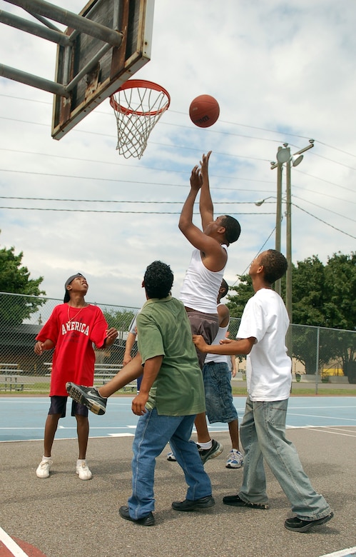 SOTO CANO AIR BASE, Honduras – Airman 1st Class Allen Marcus puts up a shot on the basketball court during the Joint Task Force-Bravo Army Forces Kid’s Day Oct. 27.  About 80 children came to the base from Hogar Tierra Santa Orphanage in Comayagua for games, swimming, a movie and lunch.  (U.S. Air Force photo by Staff Sgt. Austin M. May)