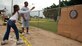 SOTO CANO AIR BASE, Honduras – Airman 1st Class Bryant Tunstalle watches Wendy Esmeralda, 15, throw darts at a dart board during the Joint Task Force-Bravo Army Forces Kid’s Day Oct. 27.  About 80 children came to the base from Hogar Tierra Santa Orphanage in Comayagua for games, swimming, a movie and lunch.  (U.S. Air Force photo by Staff Sgt. Austin M. May)