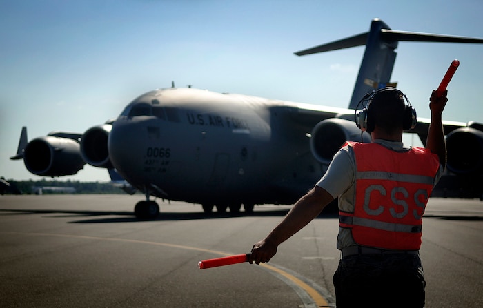 Staff Sgt. Joshua Chambliss, 437th Aircraft Maintenance Squadron special operations technician, marshals a C-17 to taxi for a local flight carrying Commander in Chief Installation Excellence Award inspector, Col. John Rutkowski, Air Mobility Command Headquarters/A3D, on the Charleston AFB flightline Tuesday. (U.S. Air Force photo/Senior Airman Nicholas Pilch)